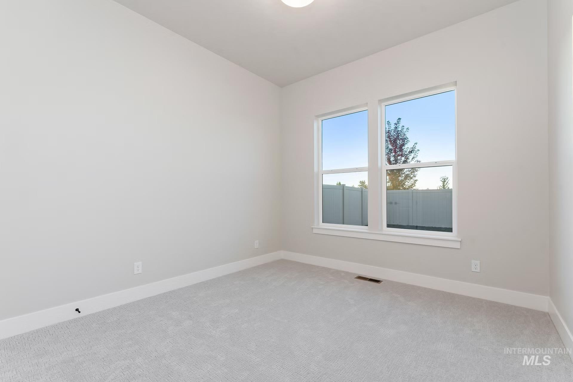 Unfurnished room featuring carpet and baseboards