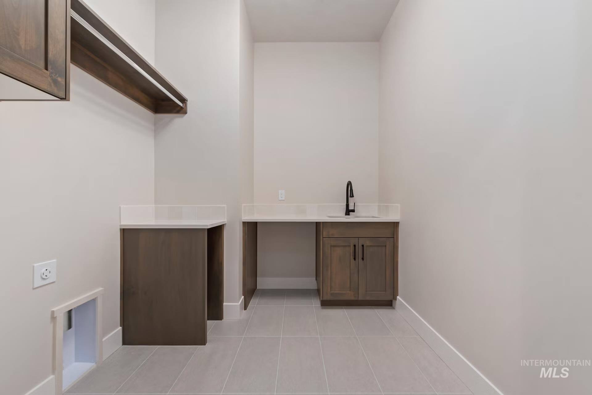 Washroom featuring light tile patterned flooring and cabinet space
