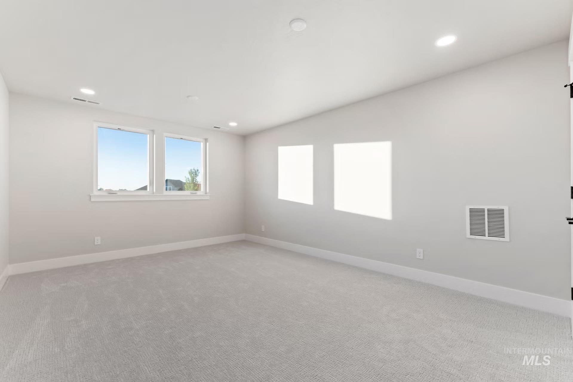 Unfurnished room with recessed lighting and light carpet