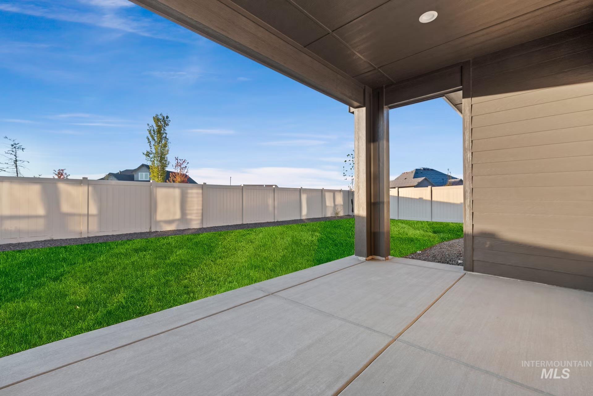 Fenced backyard featuring a patio