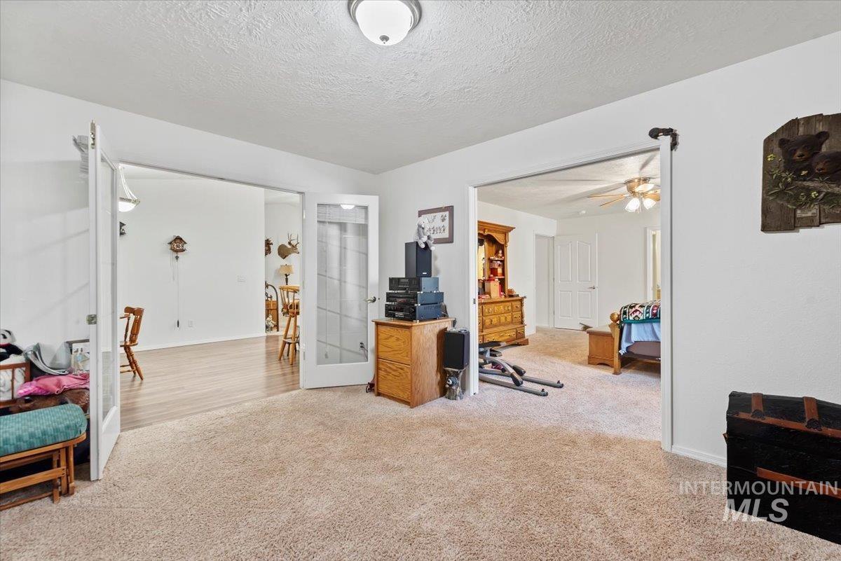 Carpeted room with french doors