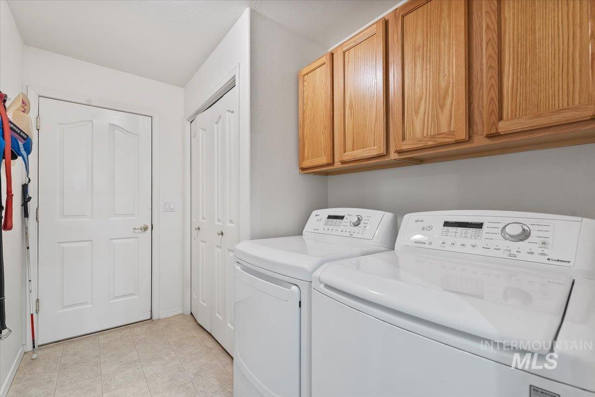 Laundry room with washer and dryer and cabinet space