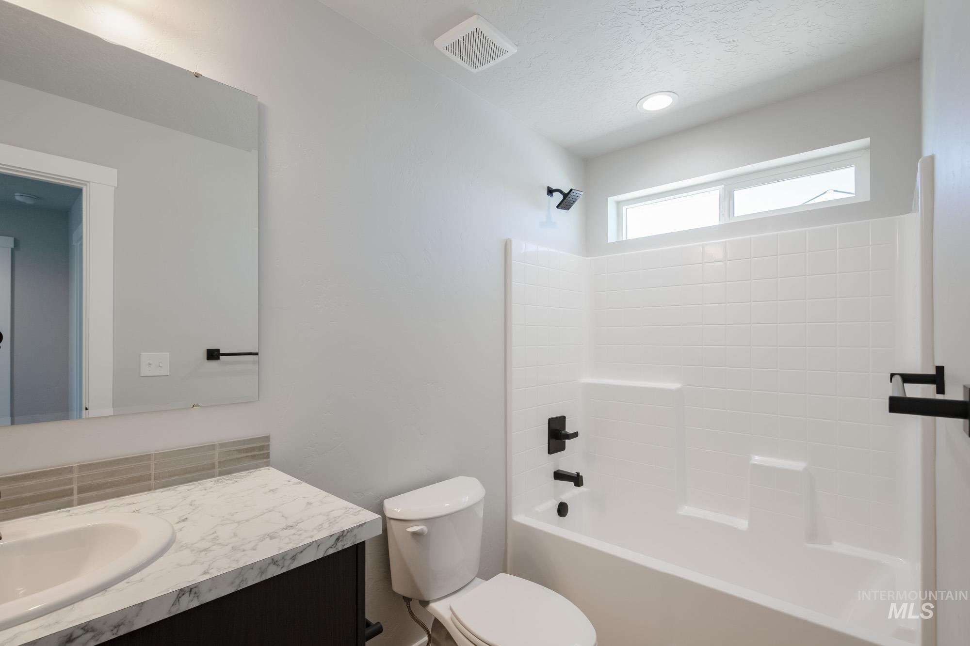 Bathroom featuring vanity and shower / washtub combination