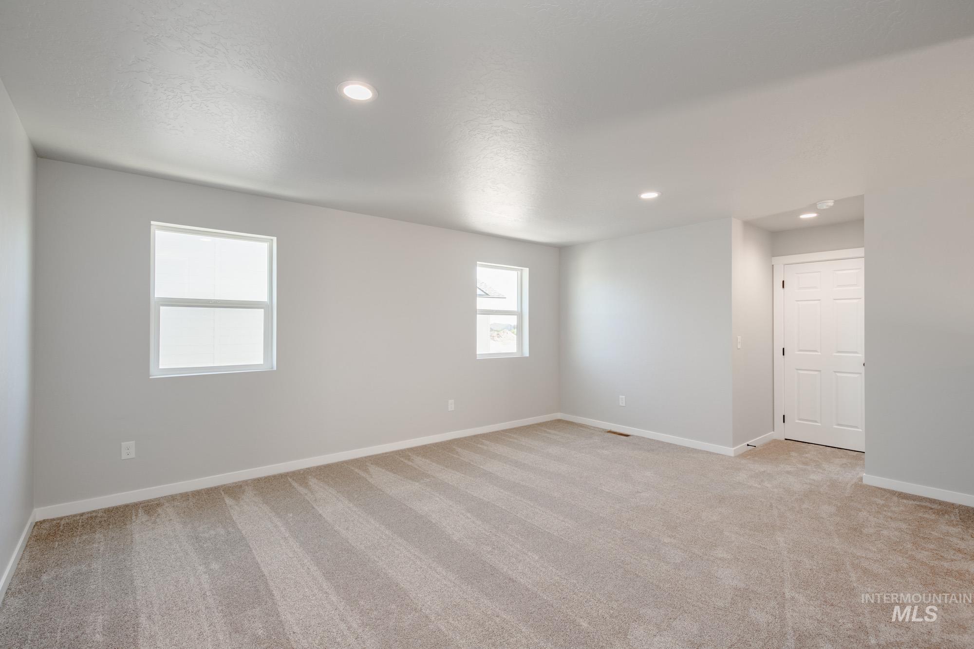 Unfurnished room featuring light colored carpet and recessed lighting