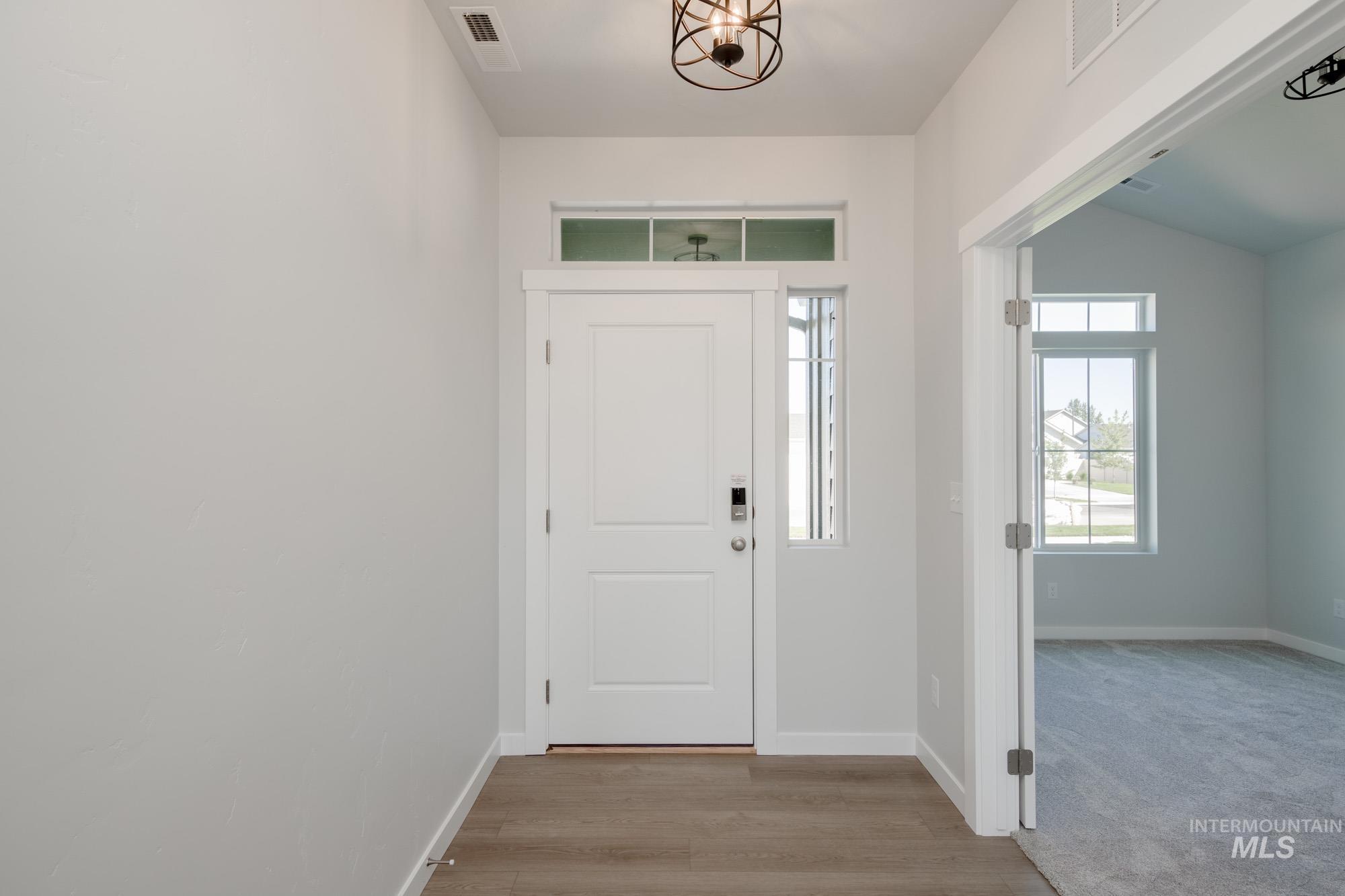Foyer with light wood-style floors