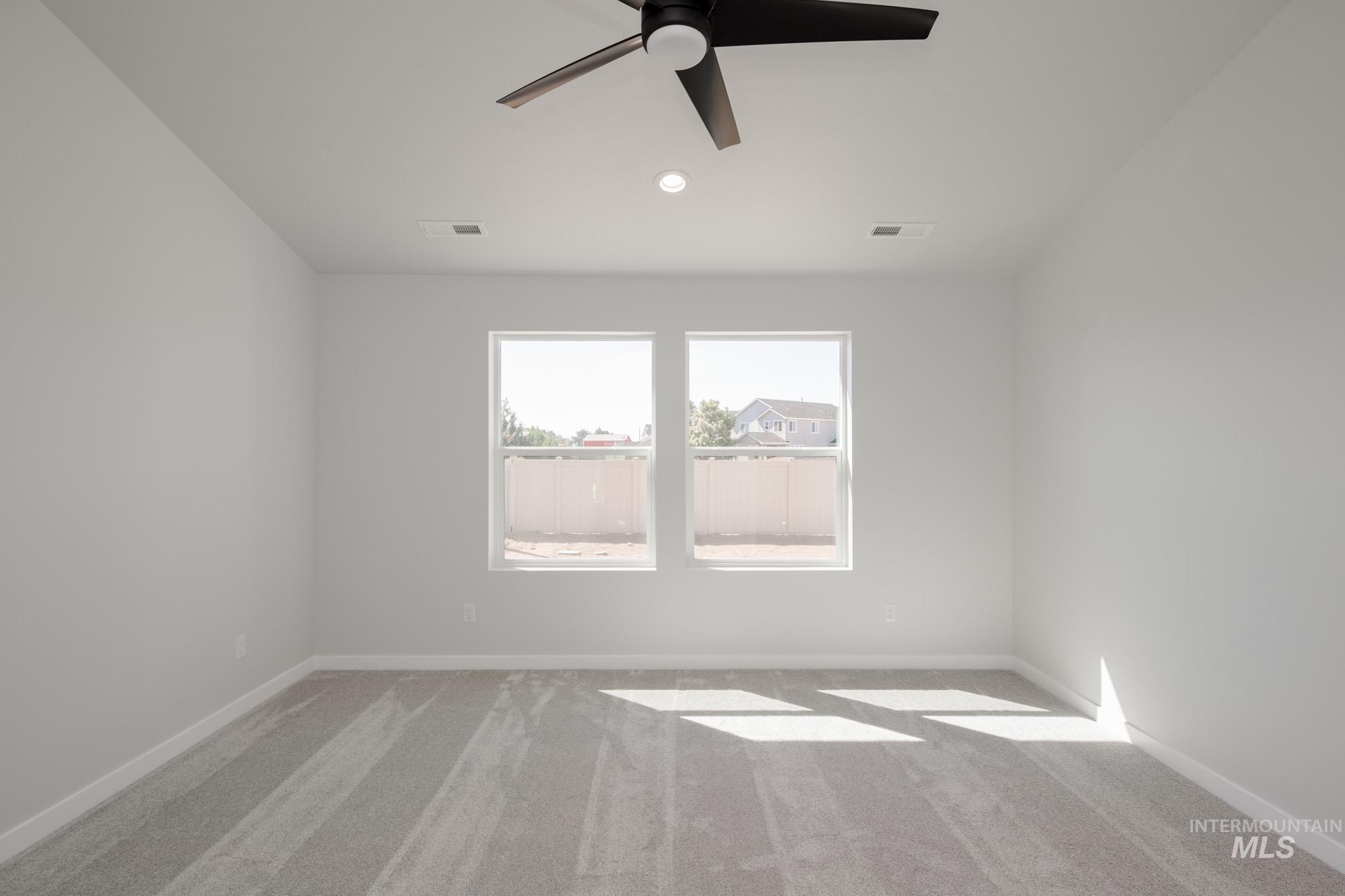 Empty room featuring carpet, a ceiling fan, and recessed lighting