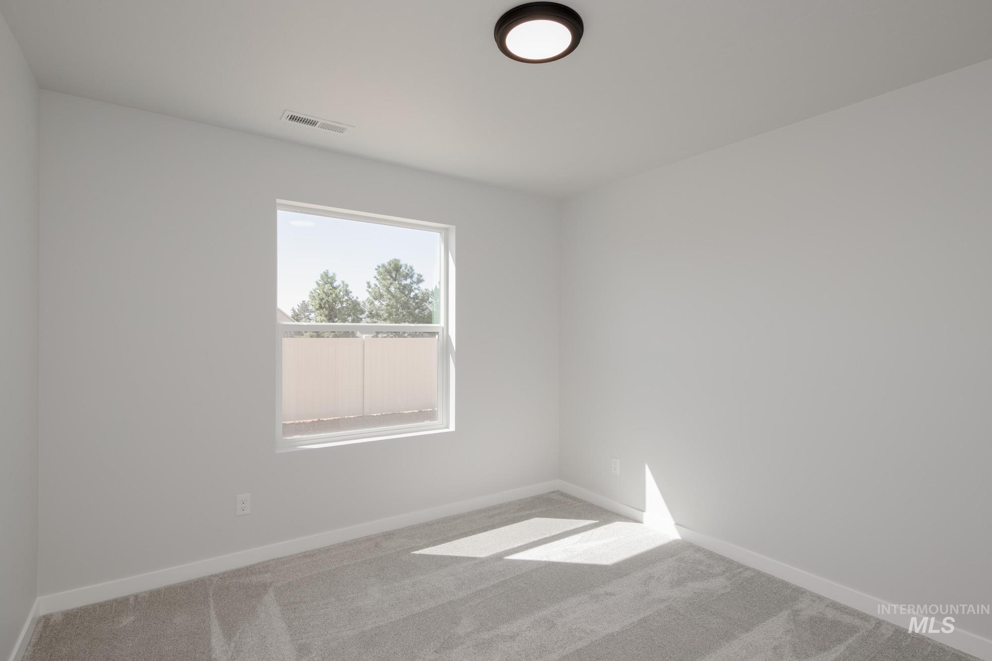 Unfurnished room featuring carpet floors and baseboards