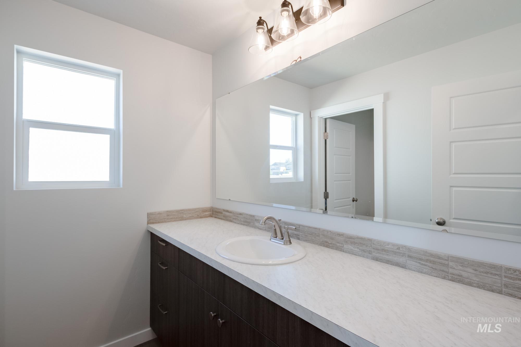 Bathroom with vanity and baseboards