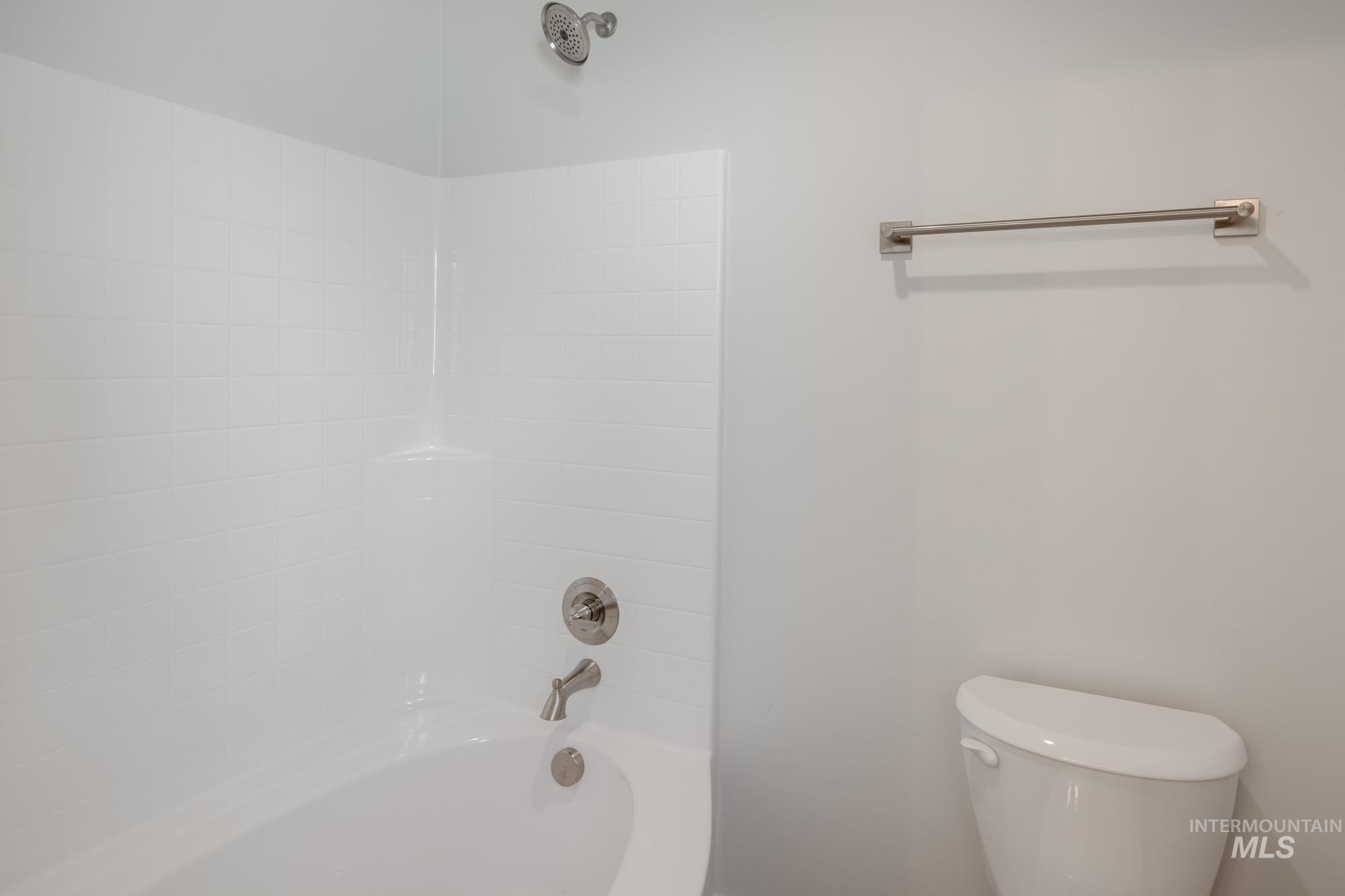 Full bath featuring shower / bathtub combination and toilet