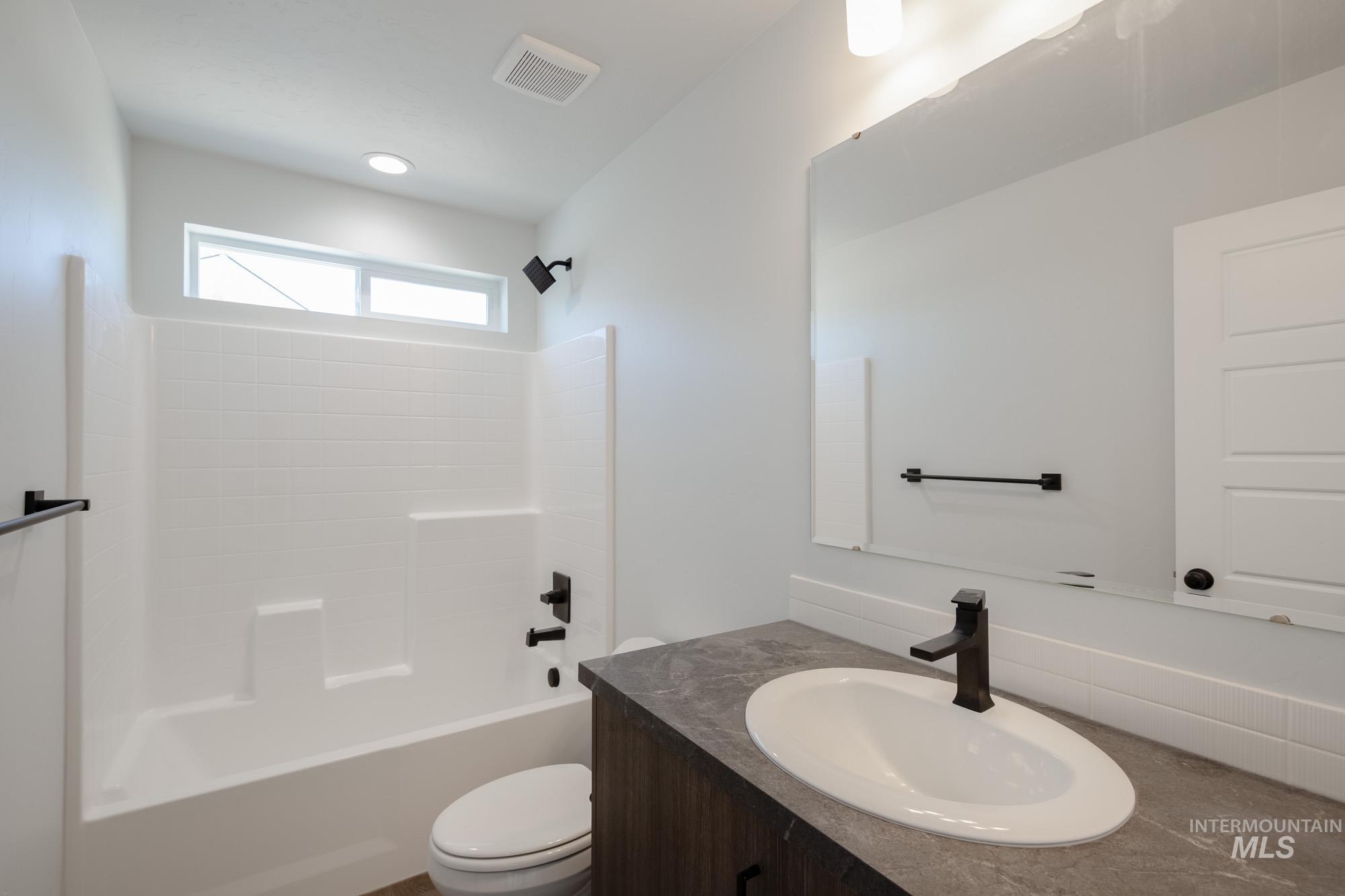 Bathroom featuring vanity and shower / bathtub combination