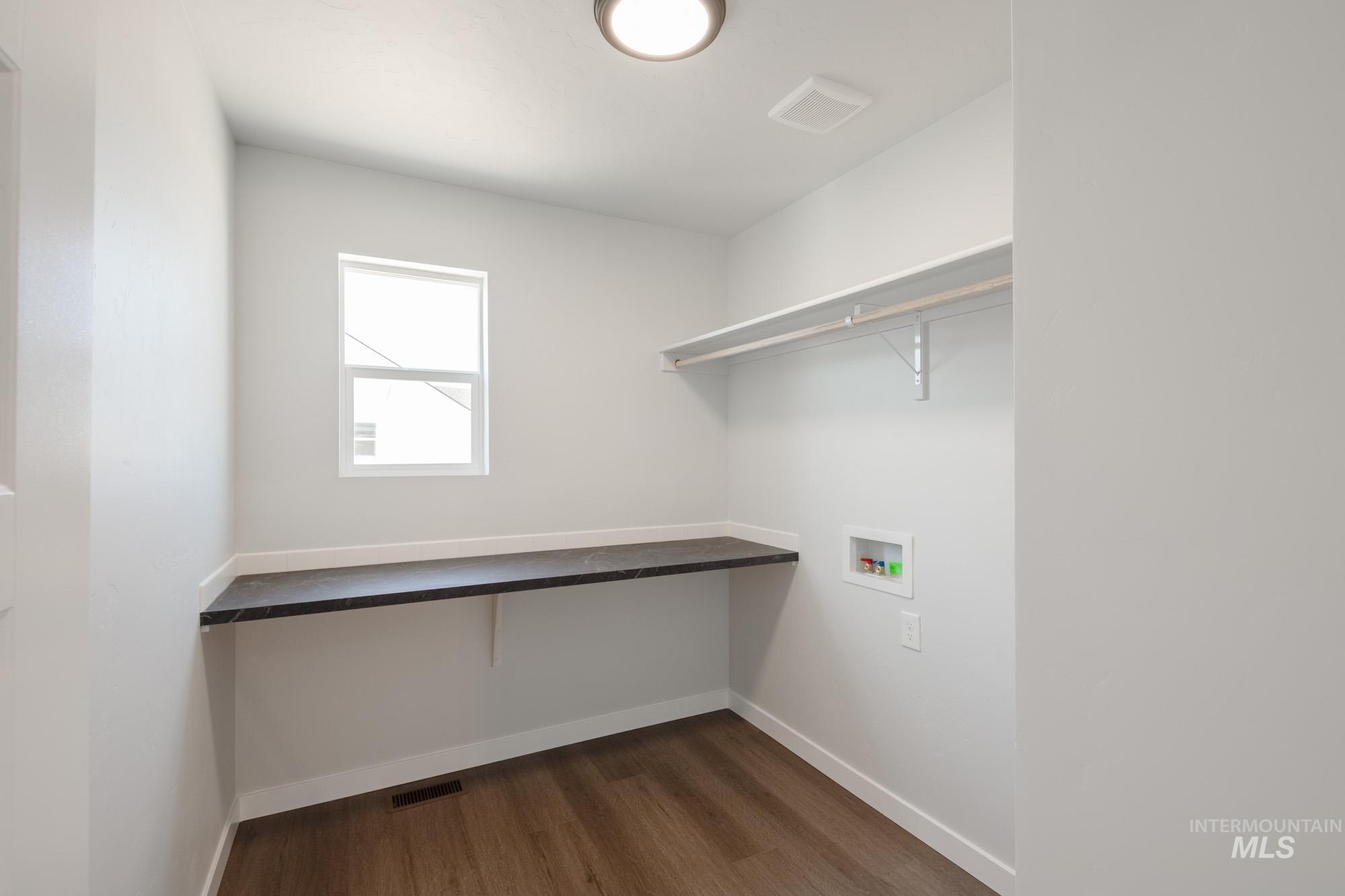 Laundry room featuring dark wood-style flooring and hookup for a washing machine