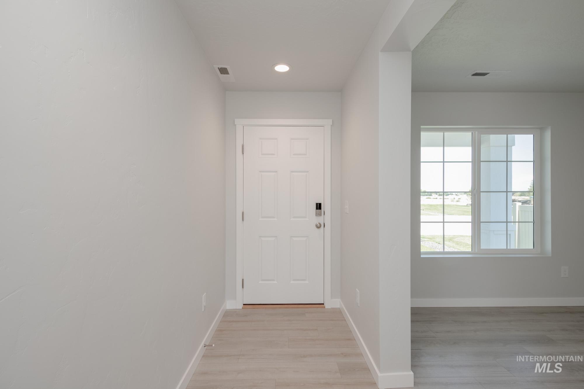 Doorway featuring recessed lighting and wood finished floors