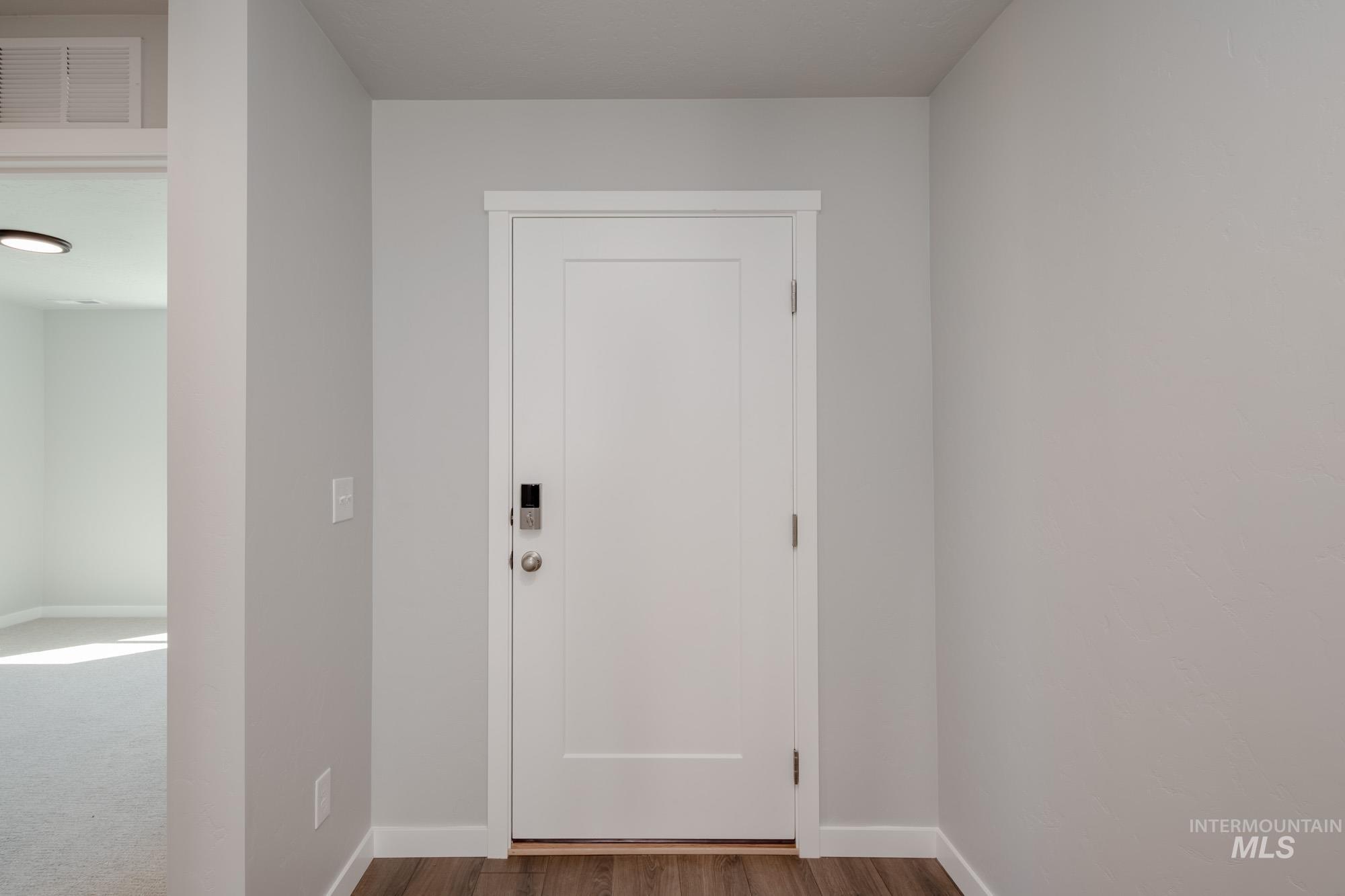 Entryway with baseboards and wood finished floors