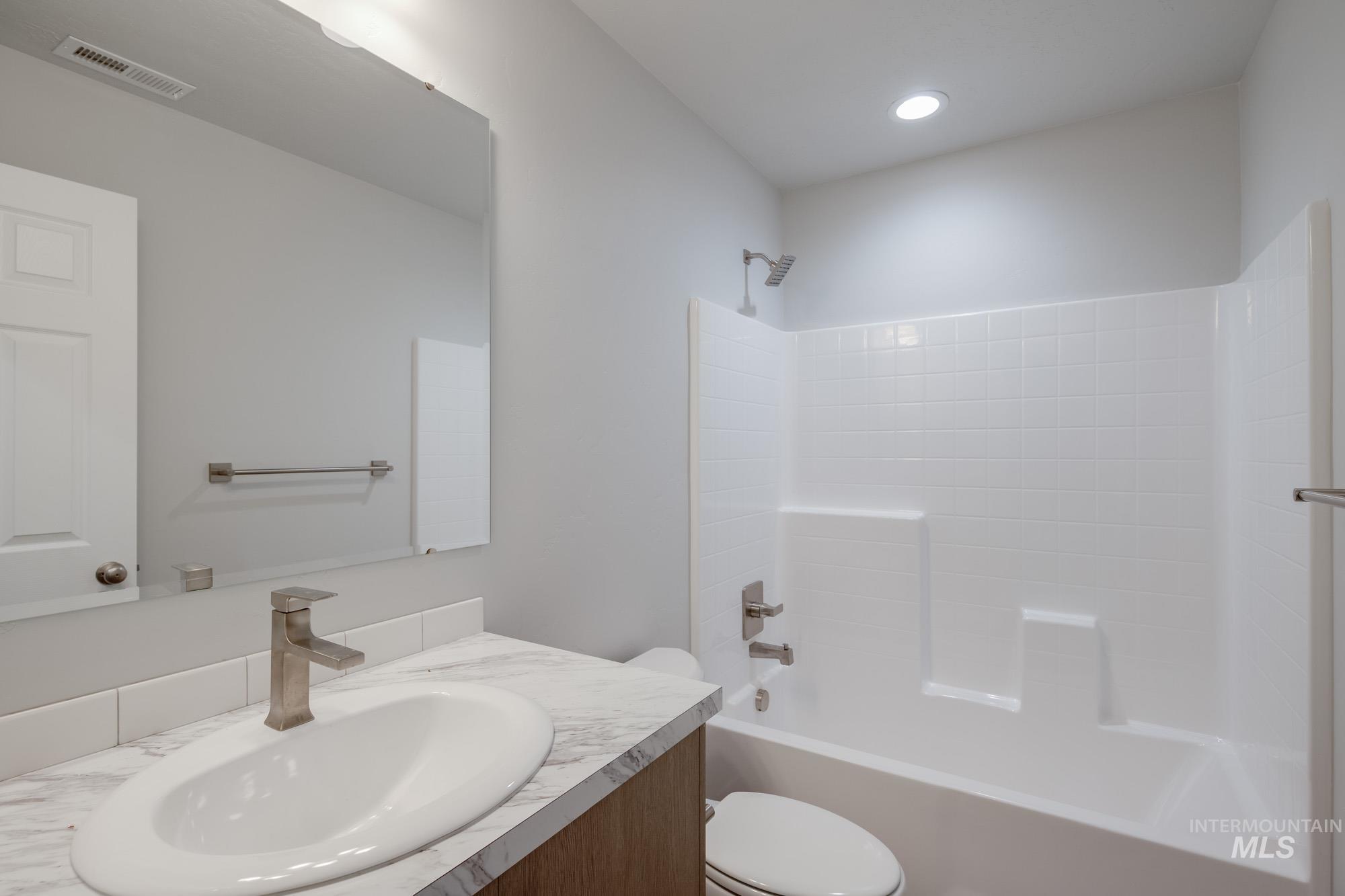 Bathroom featuring washtub / shower combination and vanity