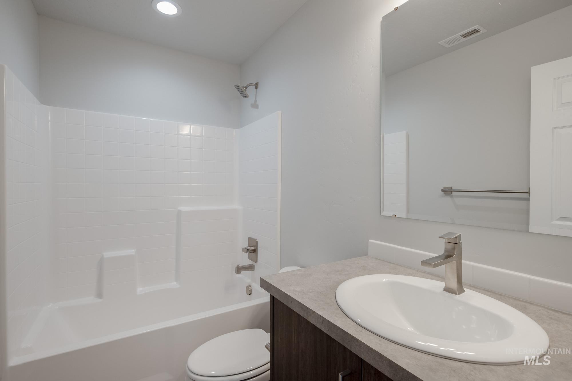 Bathroom with shower / tub combination and vanity