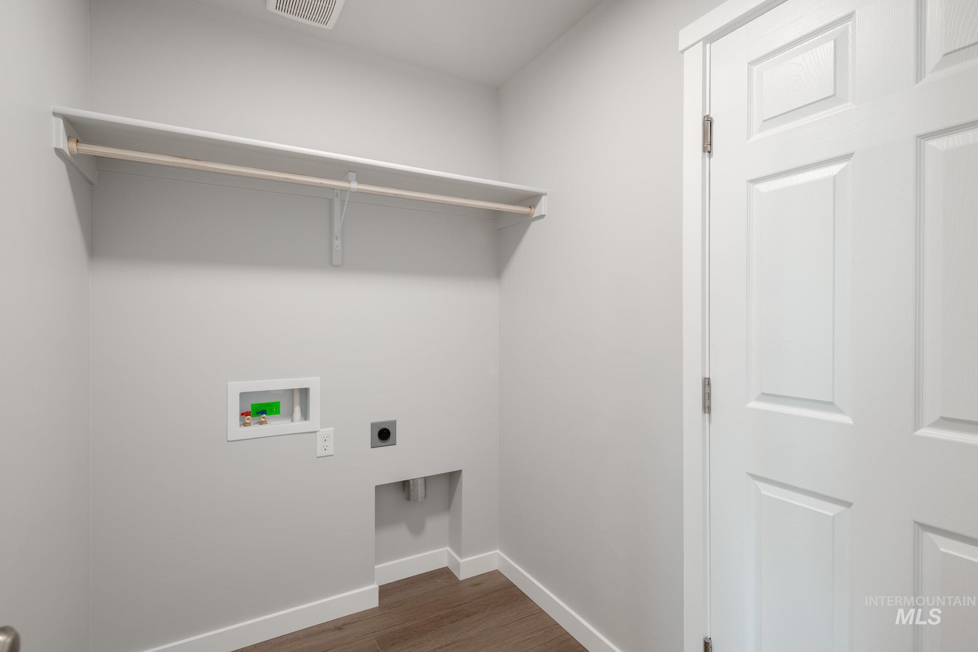 Washroom featuring dark wood-style flooring, electric dryer hookup, and hookup for a washing machine