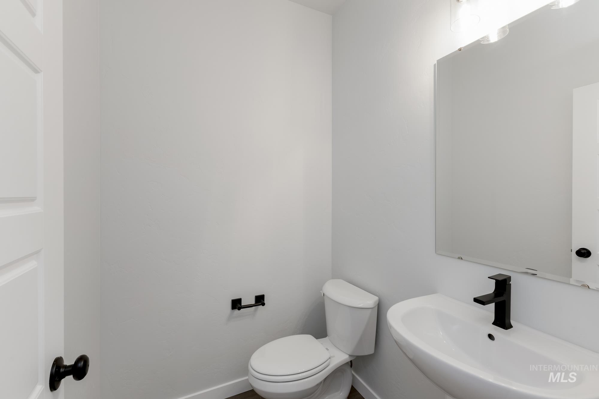 Half bathroom featuring toilet and a sink