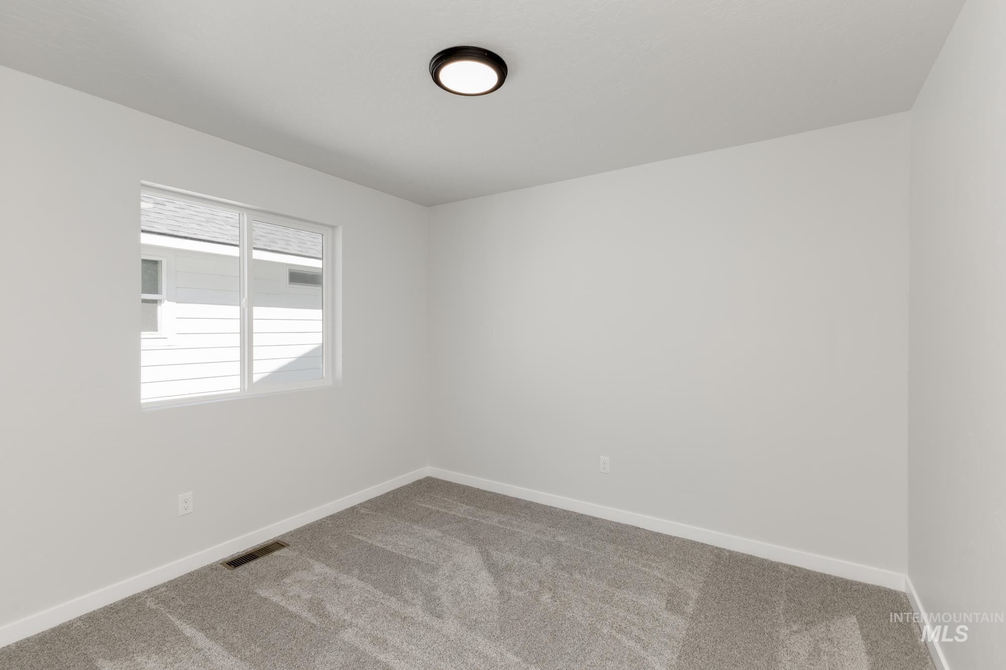 Empty room featuring carpet floors and baseboards