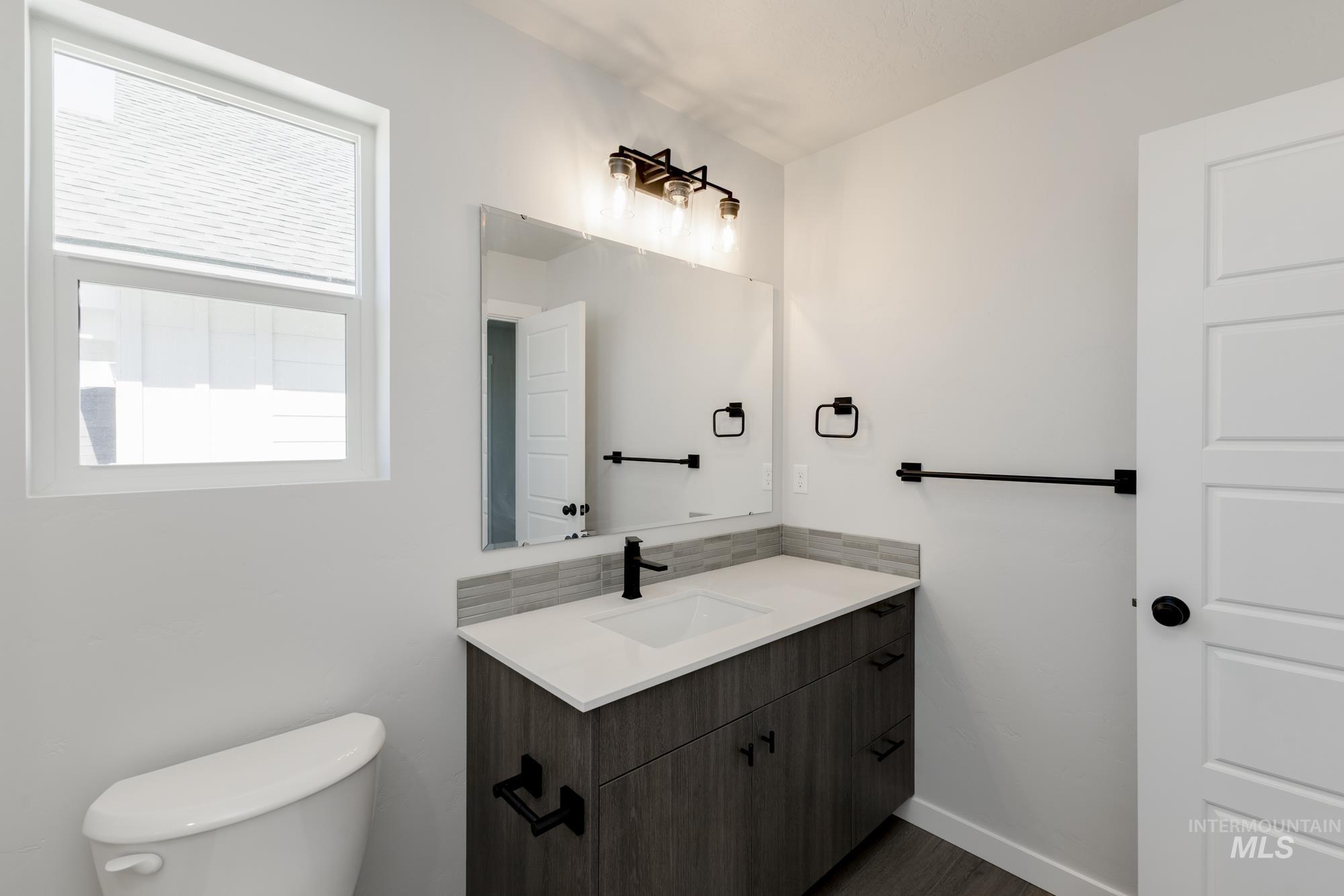 Bathroom featuring vanity and dark wood-style flooring