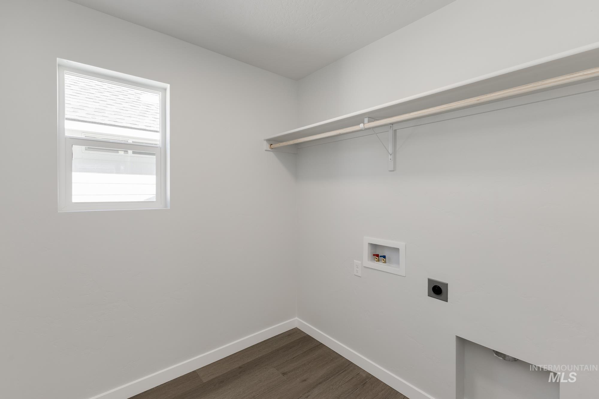 Washroom featuring dark wood finished floors, washer hookup, and electric dryer hookup