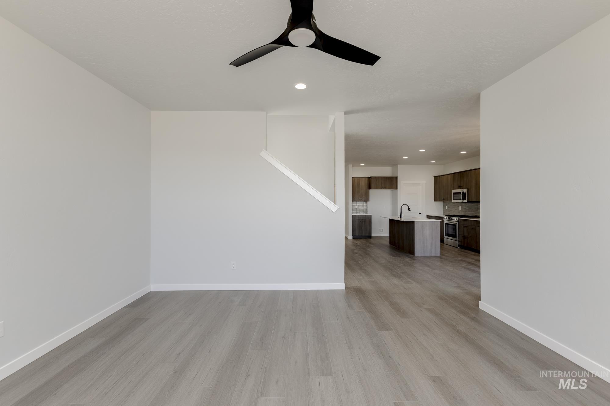 Unfurnished living room with recessed lighting, light wood-type flooring, and a ceiling fan