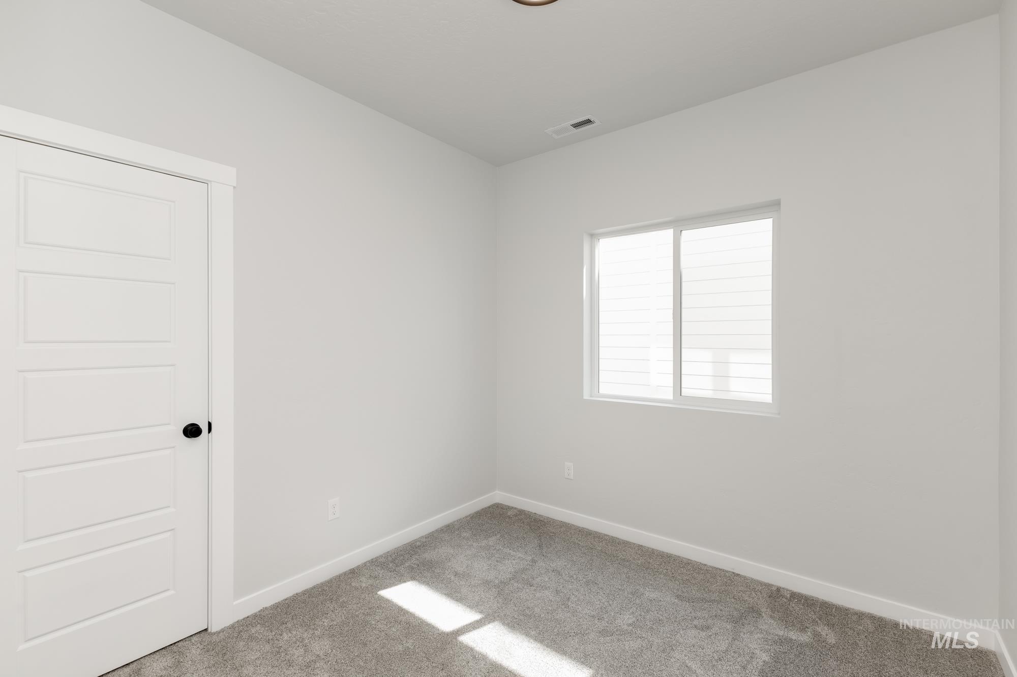 Spare room with carpet floors and baseboards