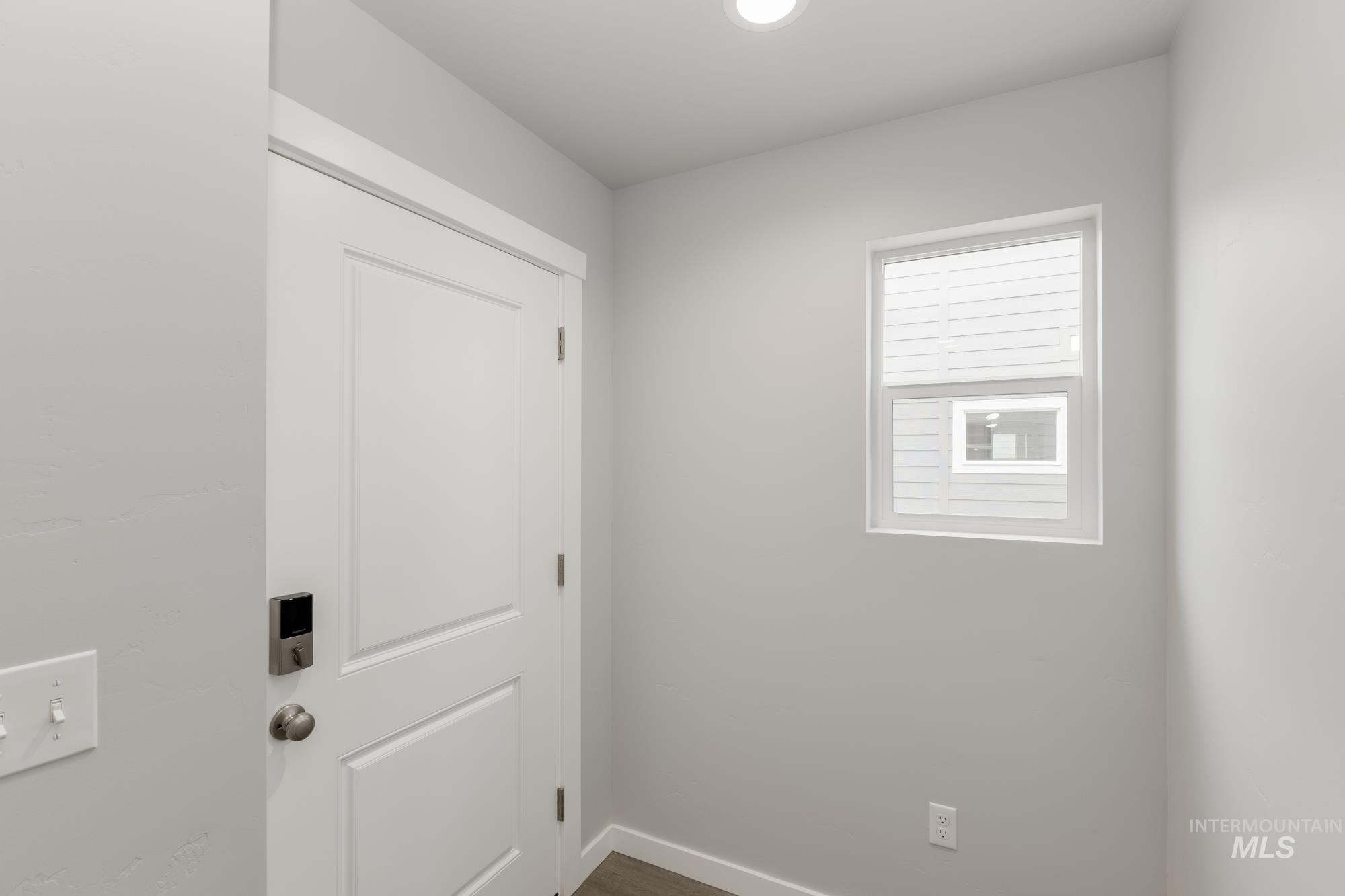 Spare room with baseboards and dark wood finished floors