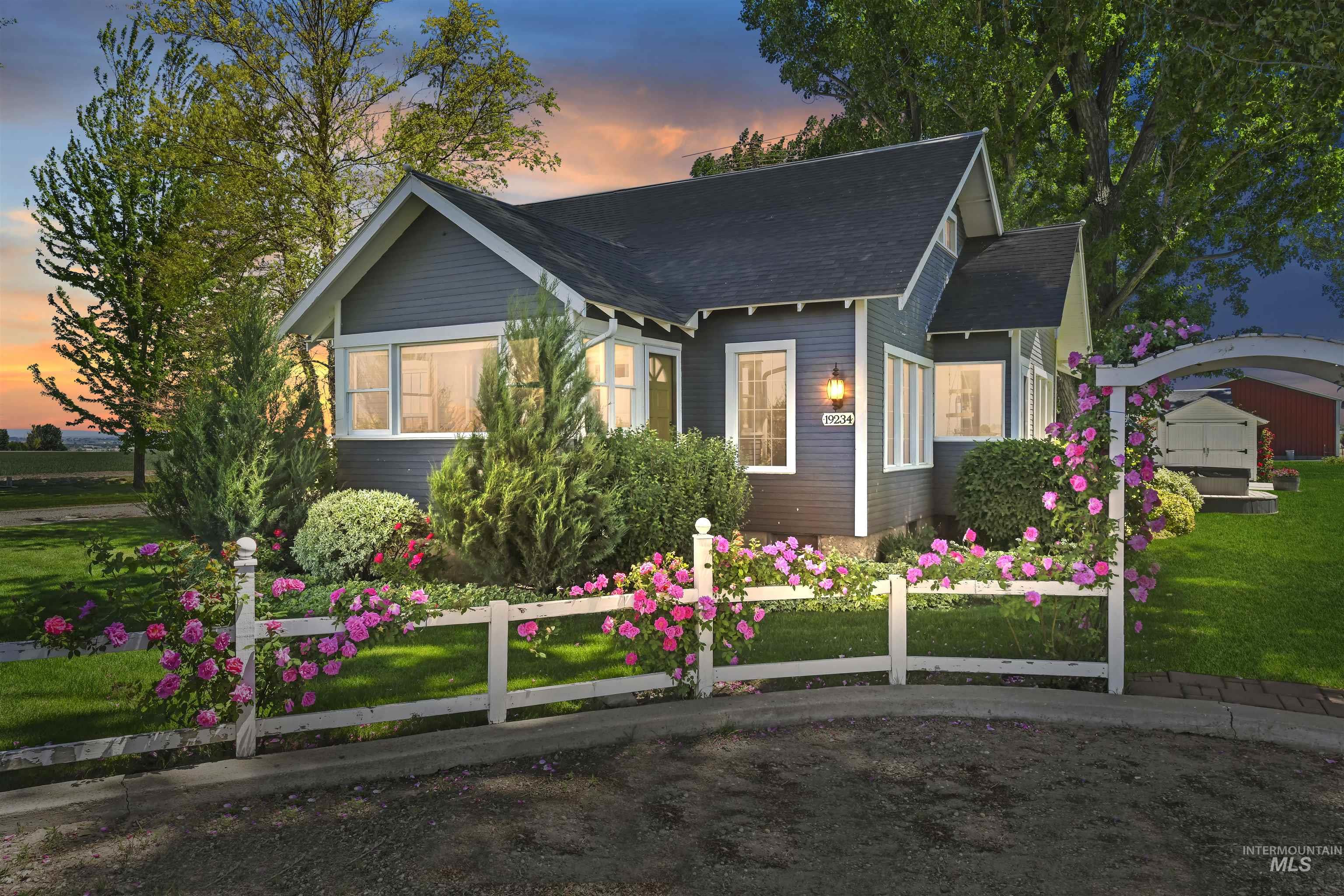 View of front of home featuring a front yard and a shingled roof