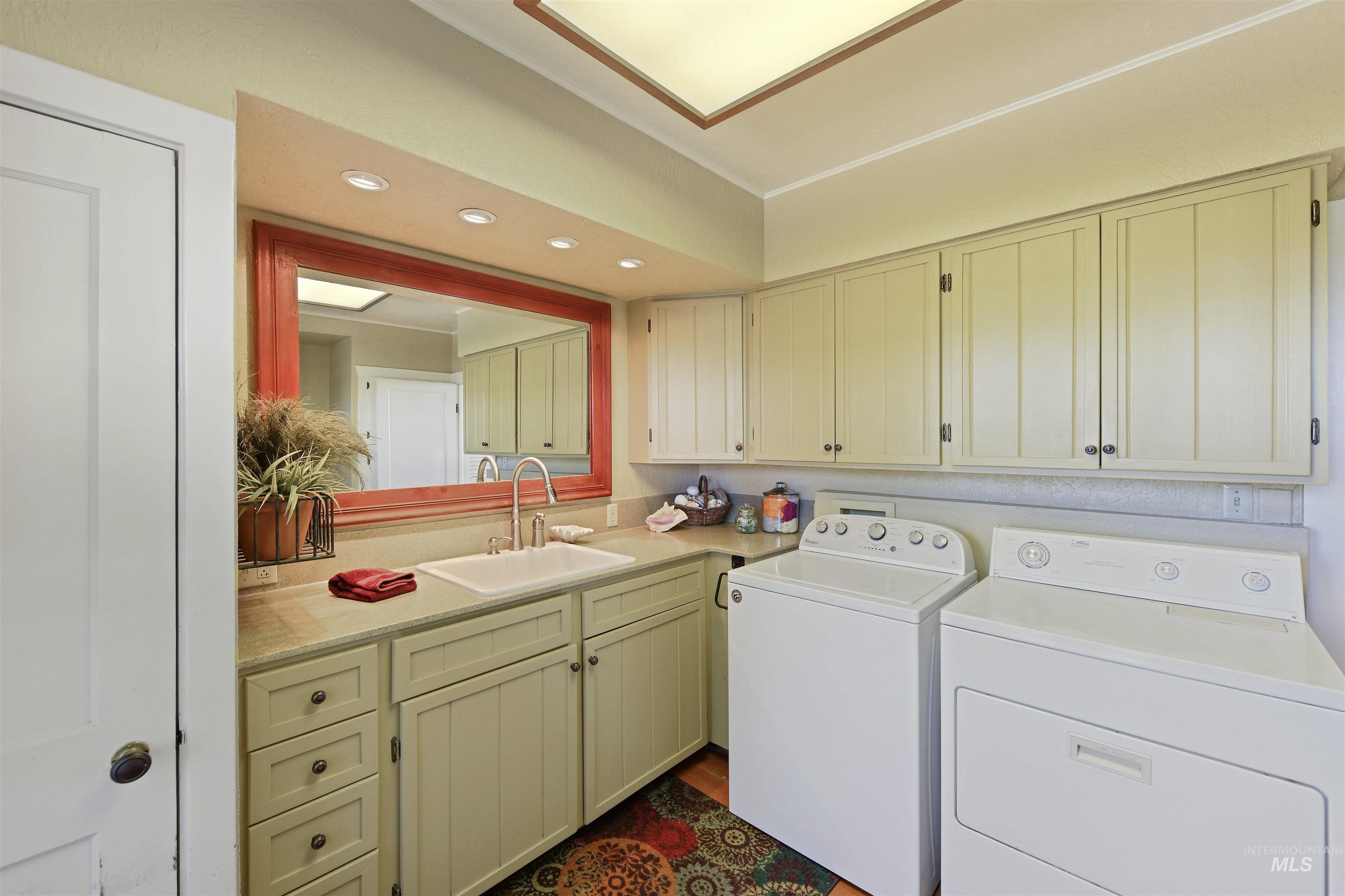 Laundry area with recessed lighting, cabinet space, and washing machine and clothes dryer