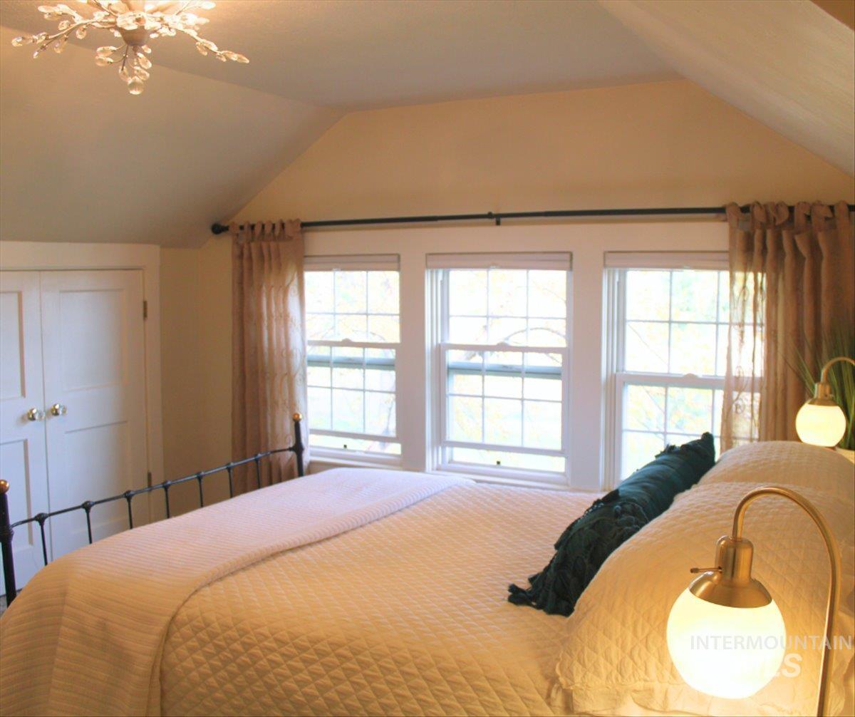 Bedroom featuring a closet and lofted ceiling