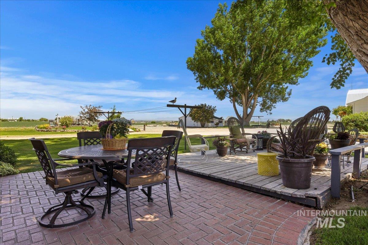 View of patio featuring outdoor dining area and a wooden deck