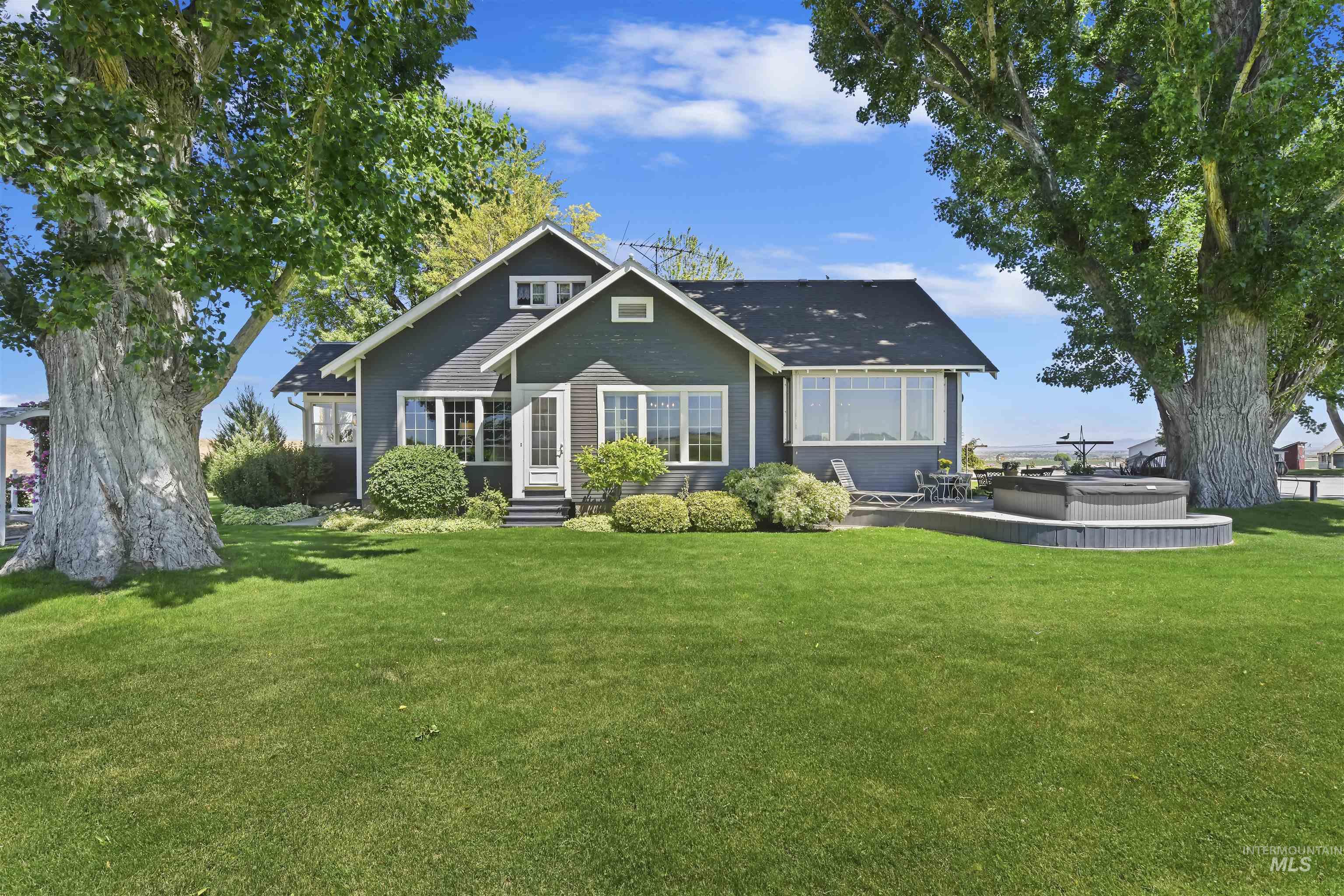 Rear view of house with a yard, a jacuzzi, entry steps, and a patio area