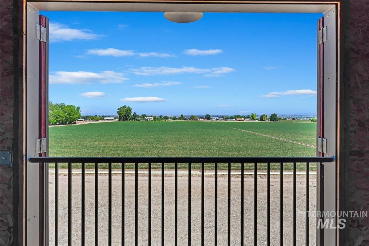 View of yard featuring a balcony and a rural view