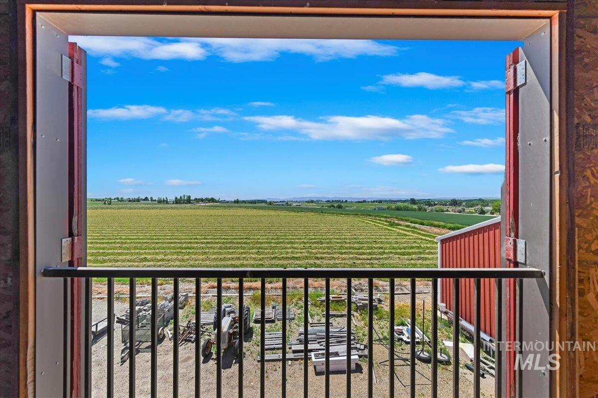 Balcony featuring agricultural area and a view of rural / pastoral area