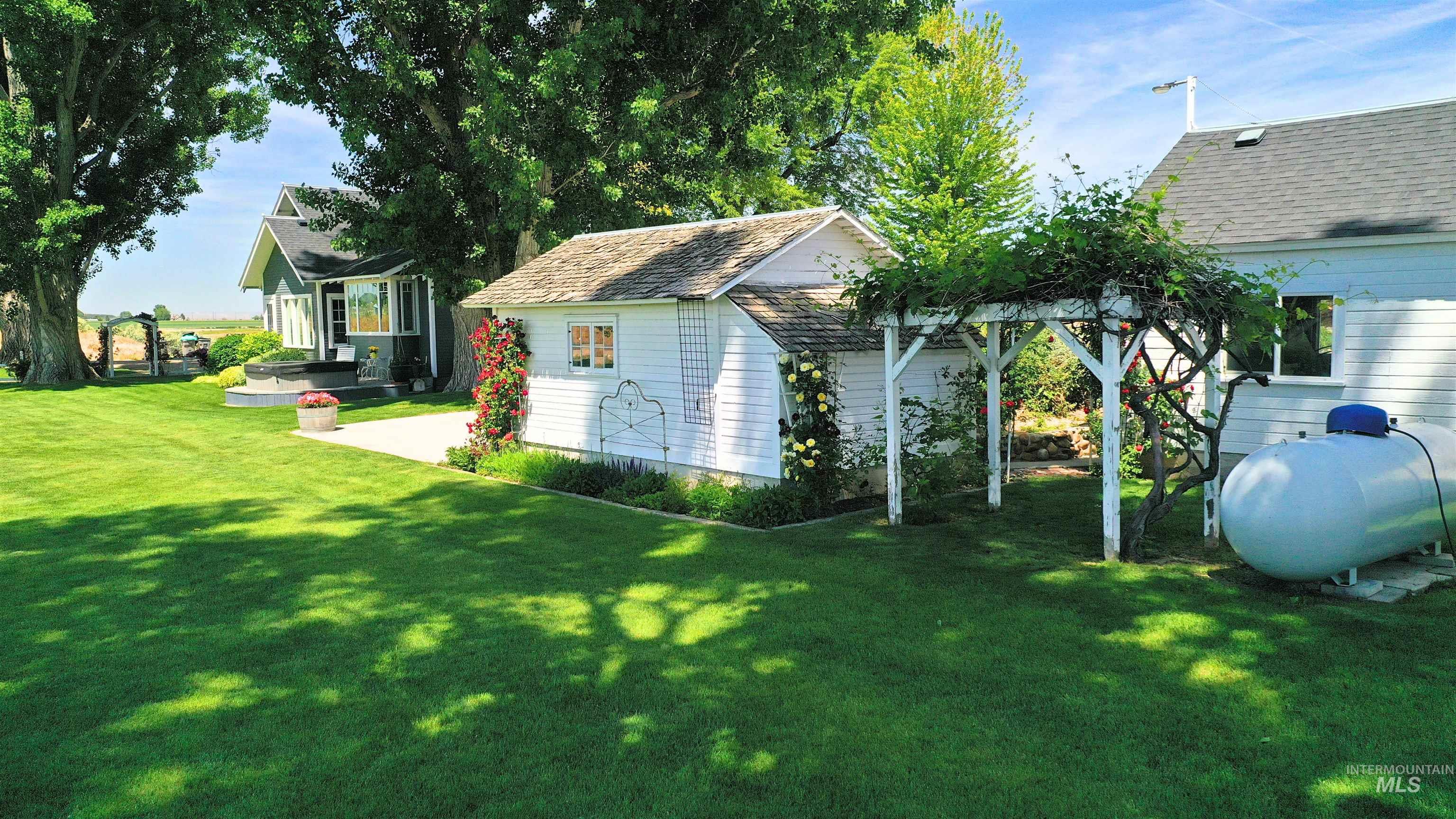 View of green lawn featuring an outbuilding