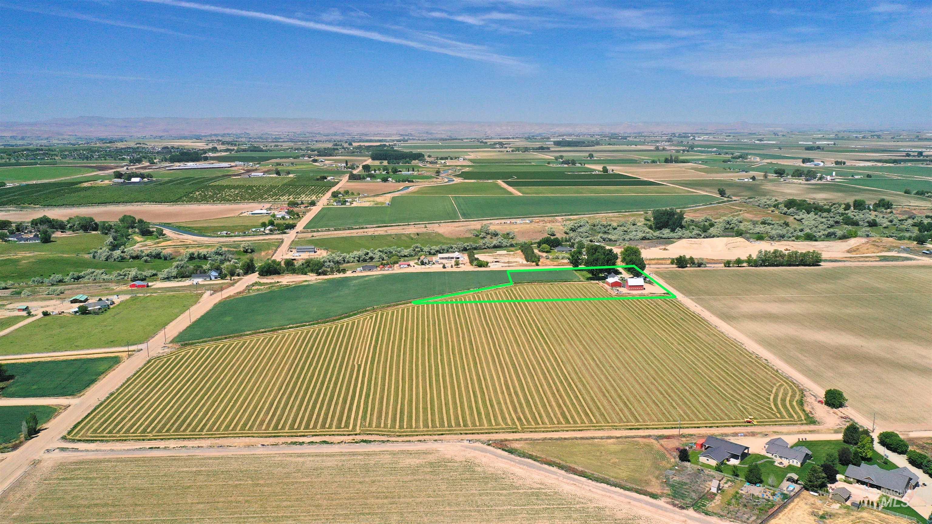 Overview of rural landscape featuring large plots for crops and property boundaries highlighted