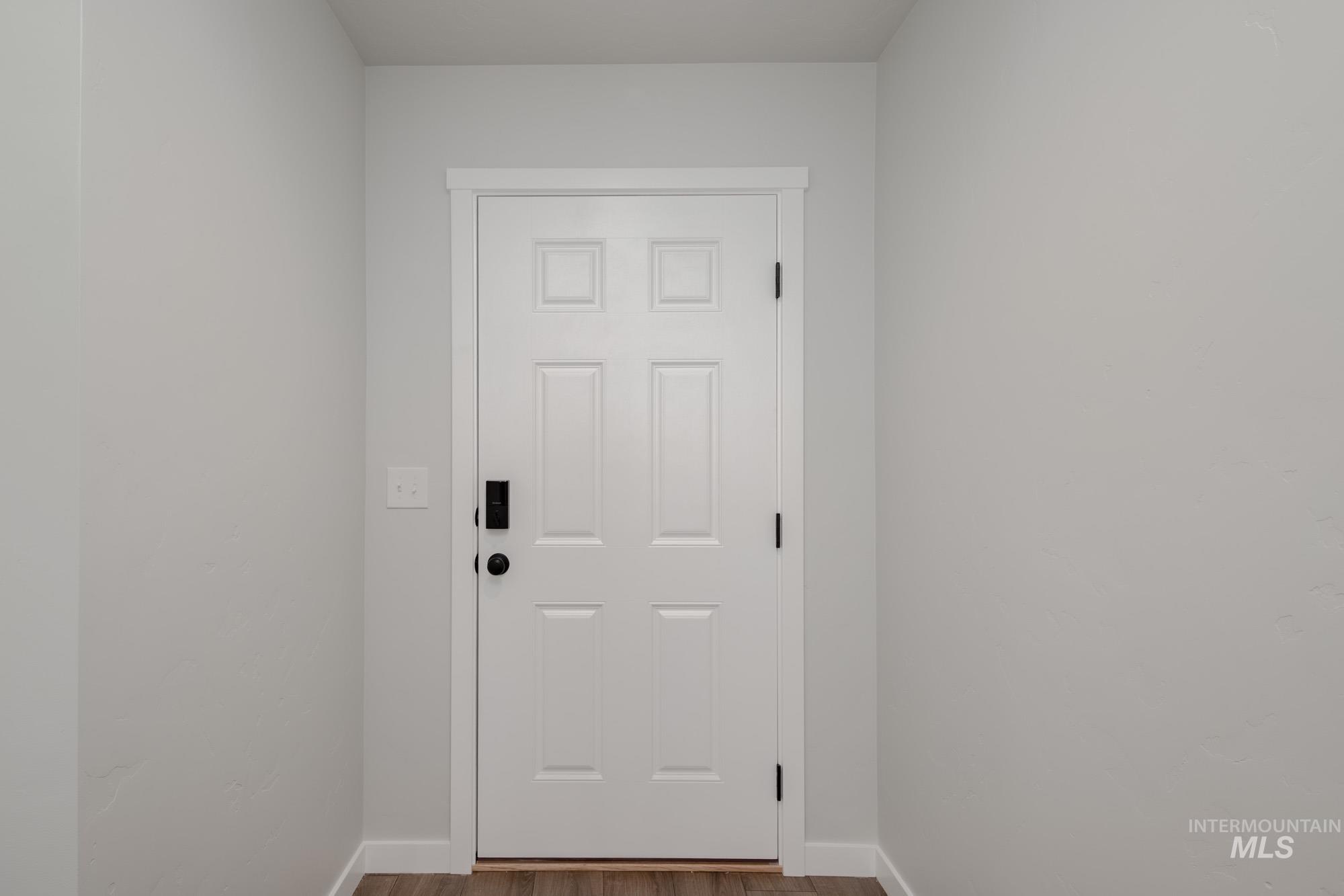 Entryway with wood finished floors and baseboards