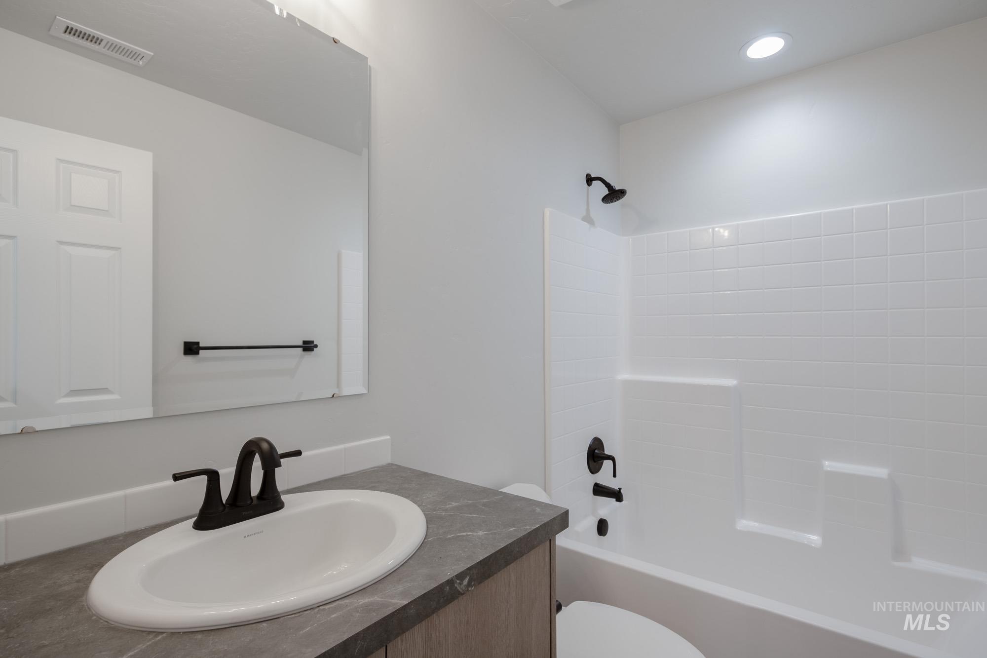 Full bathroom featuring shower / bath combination and vanity