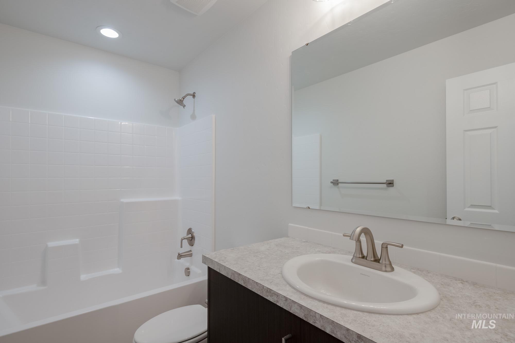 Bathroom featuring bathing tub / shower combination and vanity
