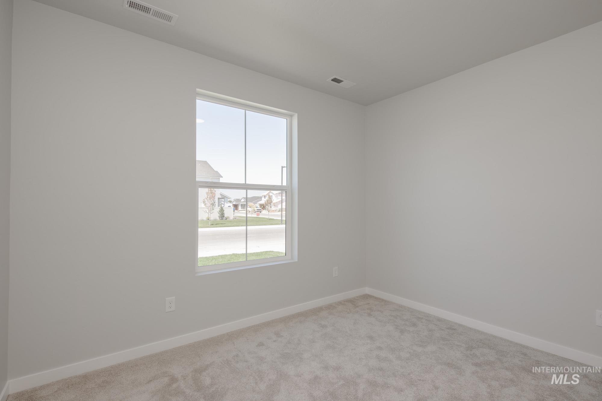 Unfurnished room featuring carpet flooring and baseboards