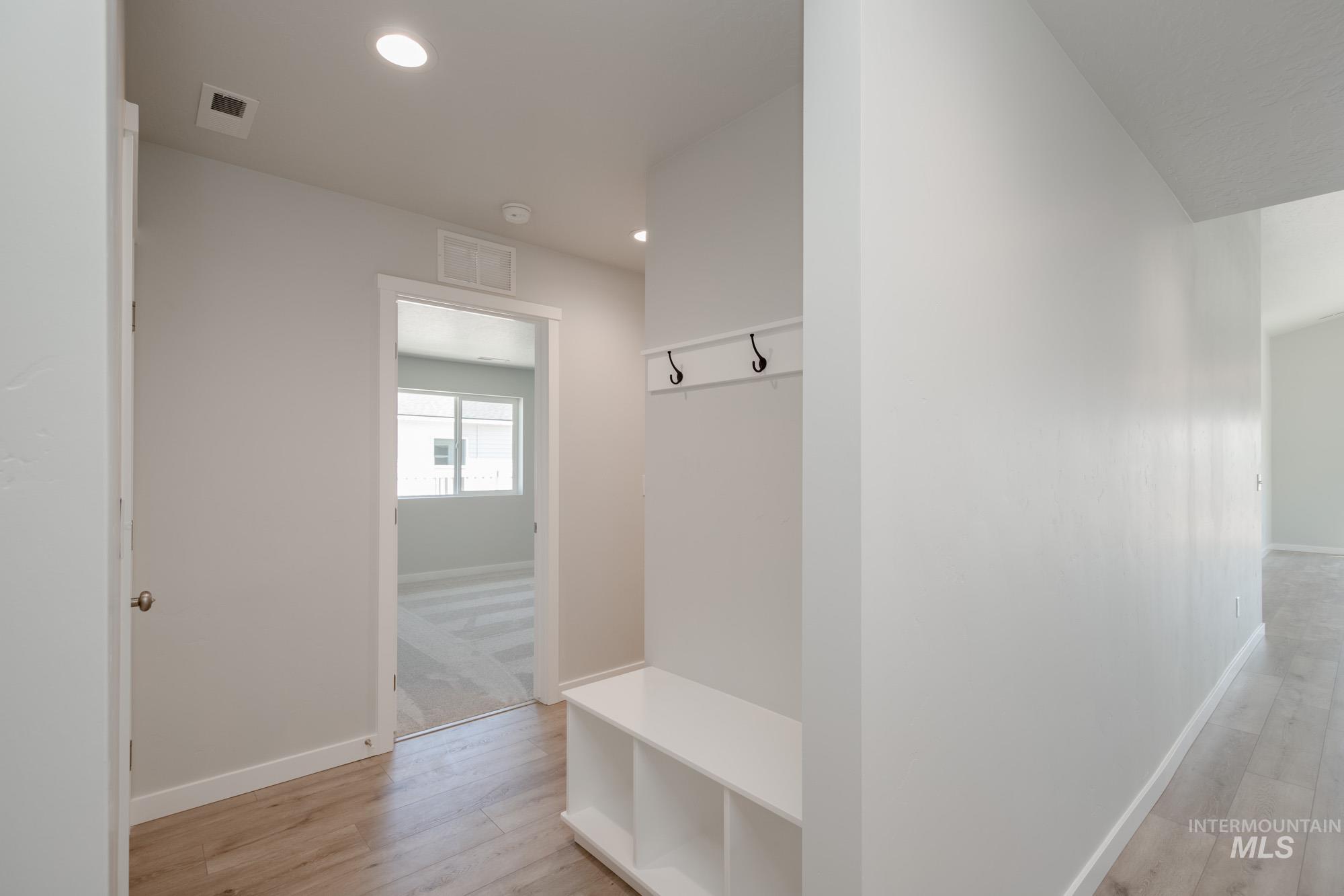 Mudroom featuring light wood finished floors and recessed lighting