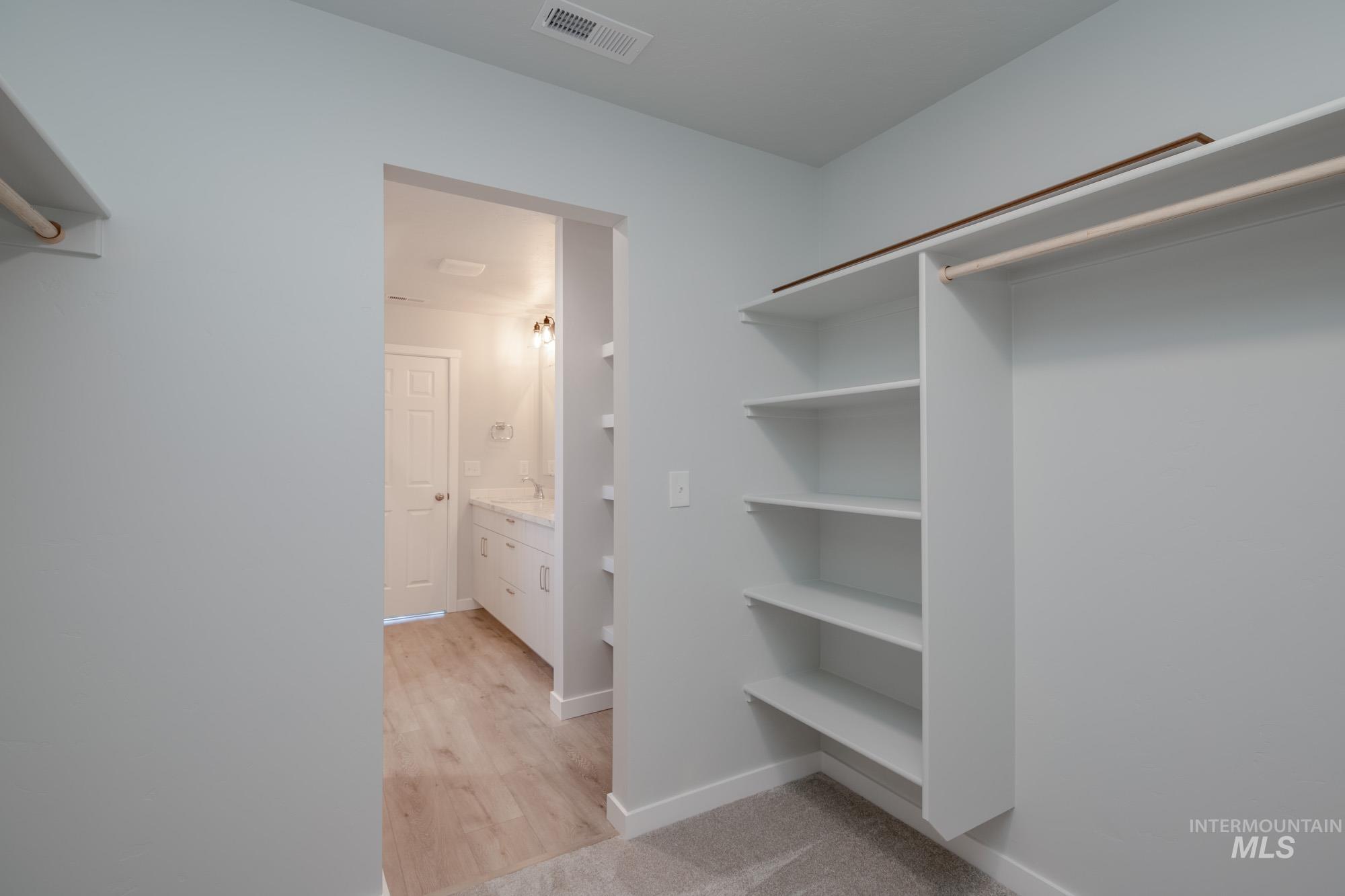 Spacious closet with light wood-type flooring