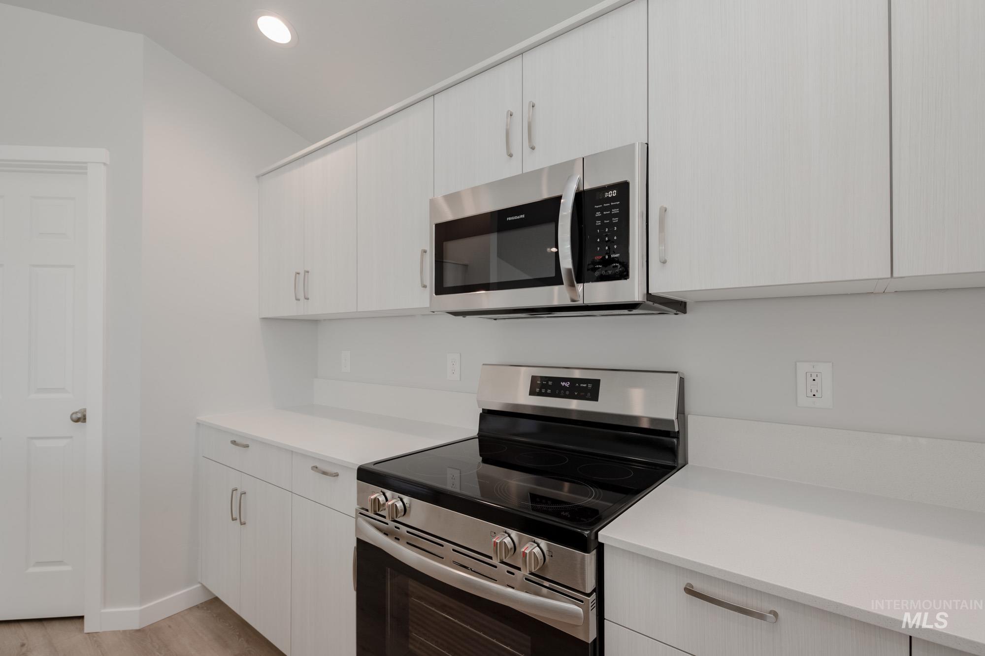 Kitchen featuring stainless steel appliances, recessed lighting, light wood-style floors, and modern cabinets