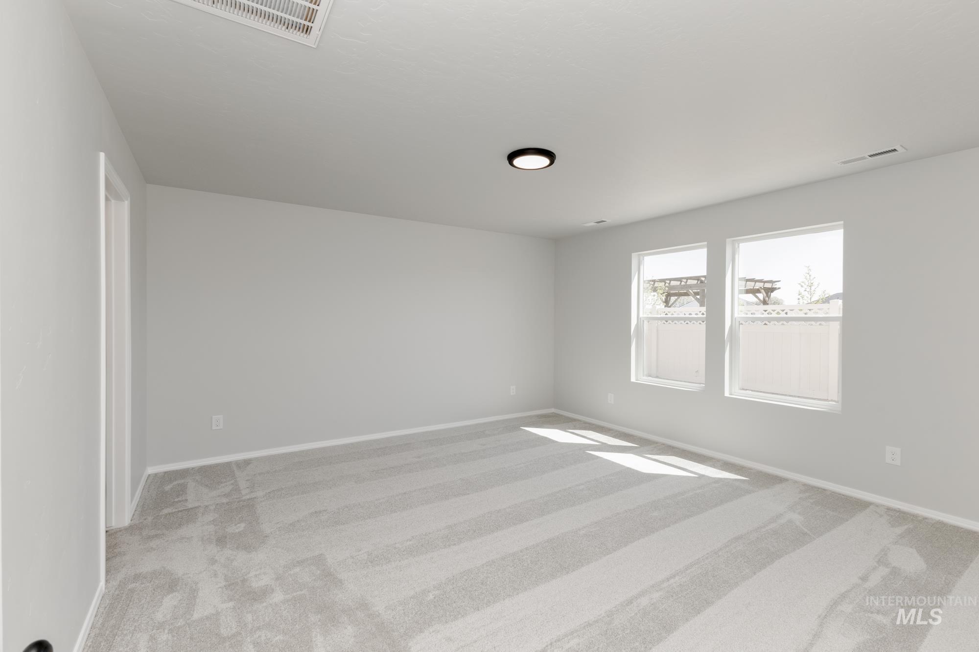 Spare room featuring light colored carpet