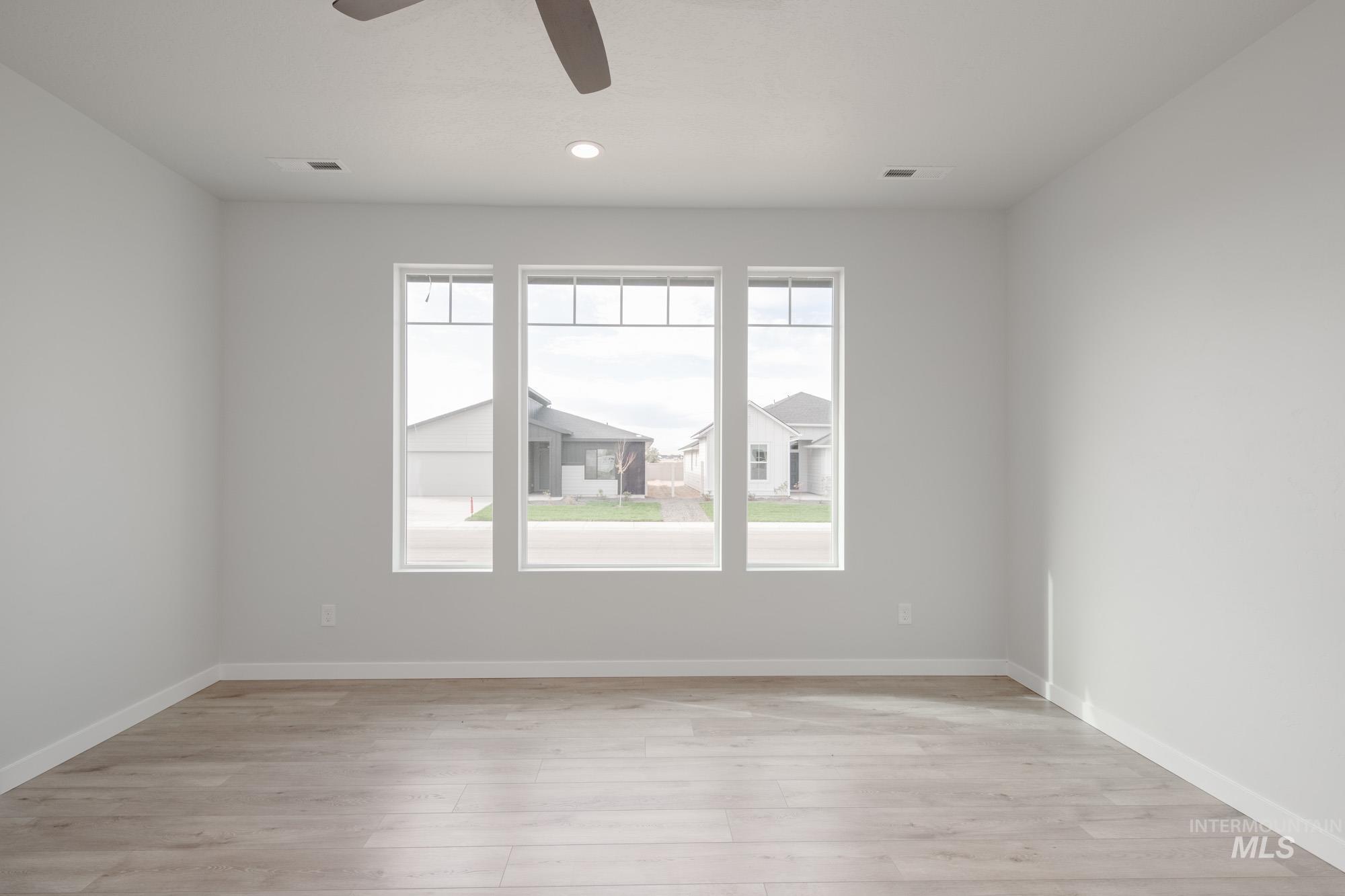 Empty room with light wood-style floors, ceiling fan, and recessed lighting