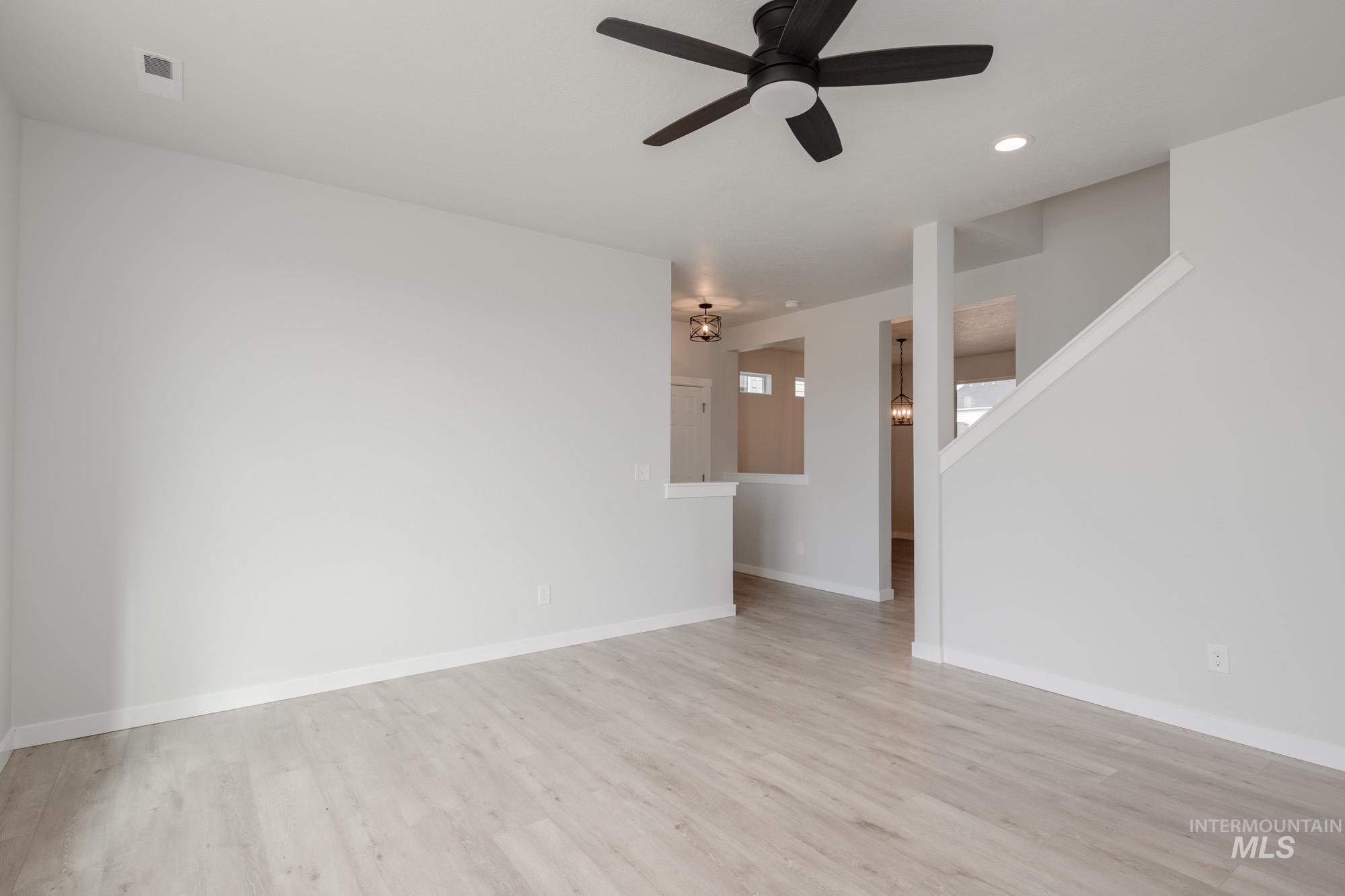 Unfurnished living room with light wood-style flooring, recessed lighting, and a ceiling fan