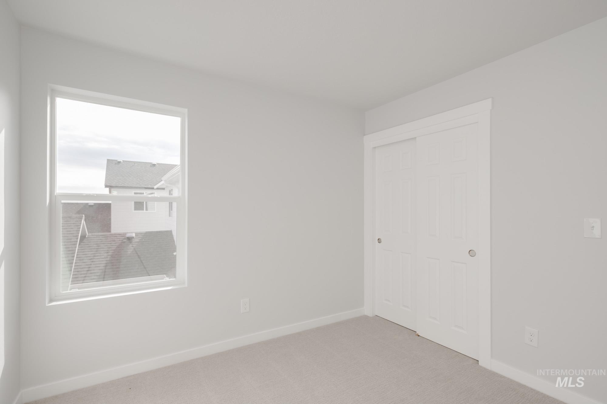 Unfurnished bedroom featuring carpet and a closet
