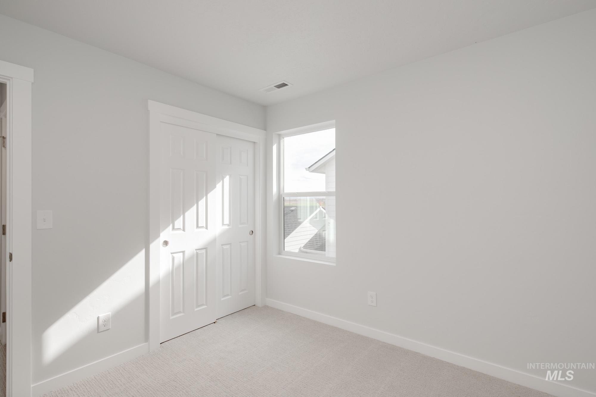 Unfurnished bedroom with carpet floors and a closet