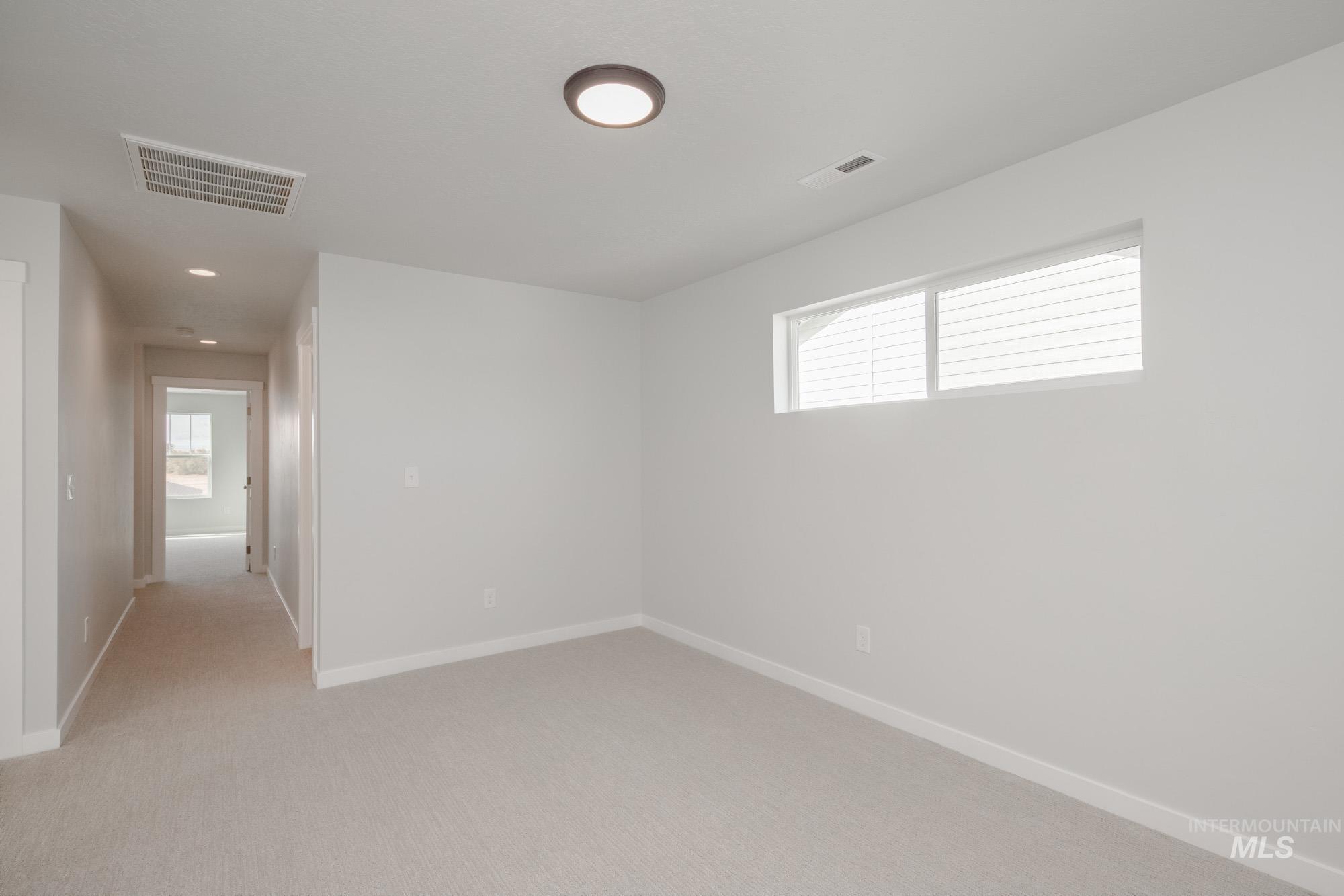 Spare room featuring light carpet and recessed lighting