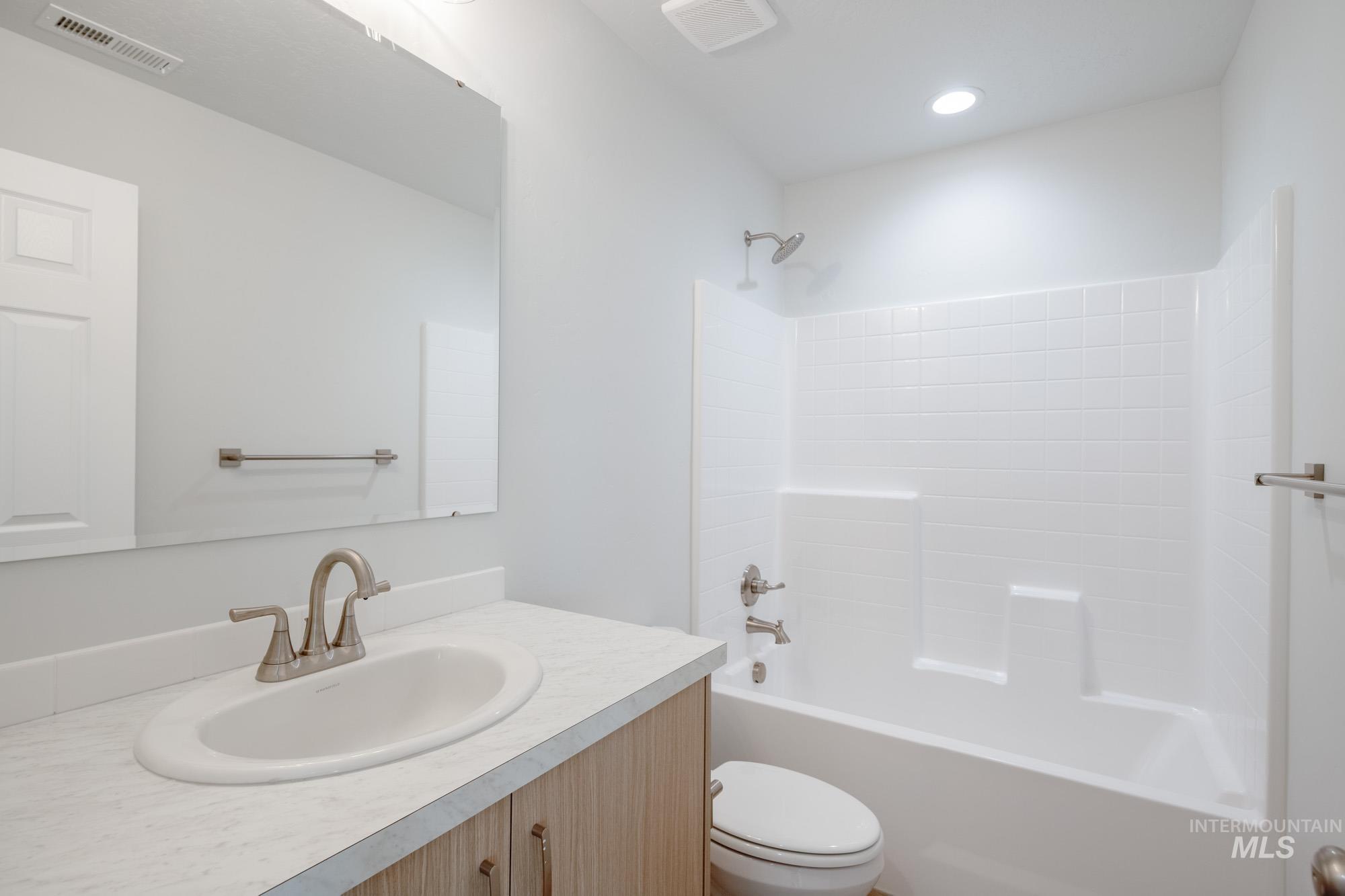 Full bath featuring shower / bathtub combination and vanity